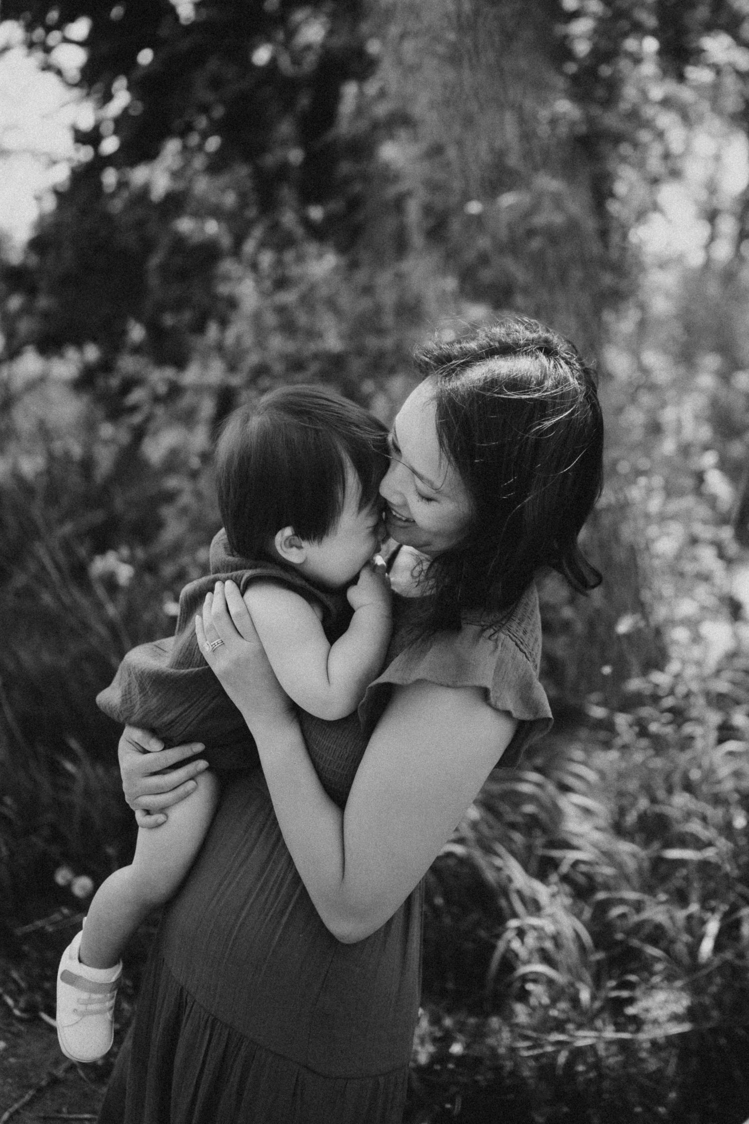 A tender moment between parent and child in a natural outdoor setting.