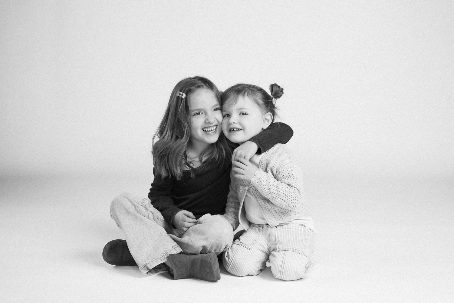 A series of black and white photographs showing intimate moments between parent and child on white background.