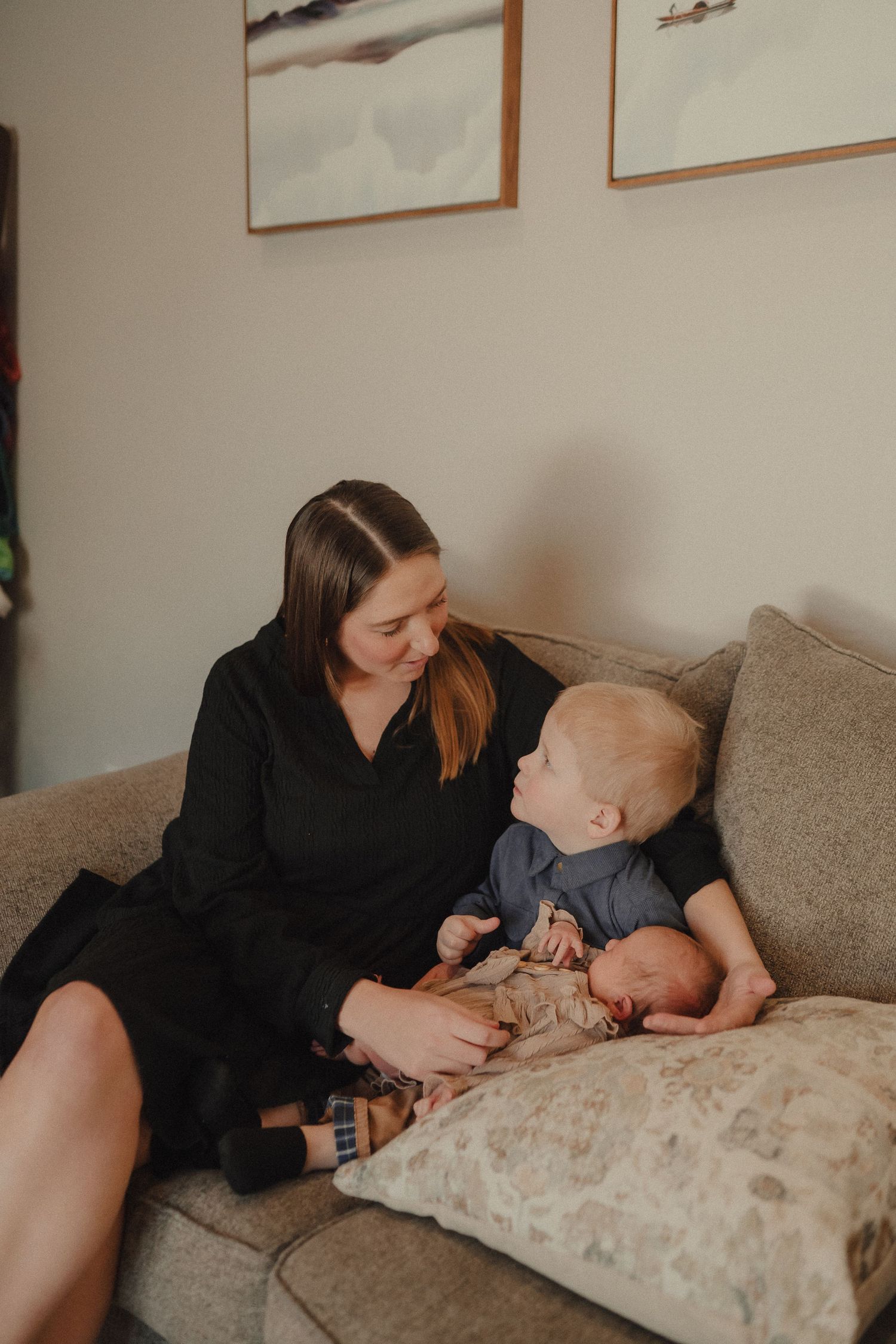 Intimate moments captured on a comfortable couch showing gentle affection and connection in warm indoor lighting.
