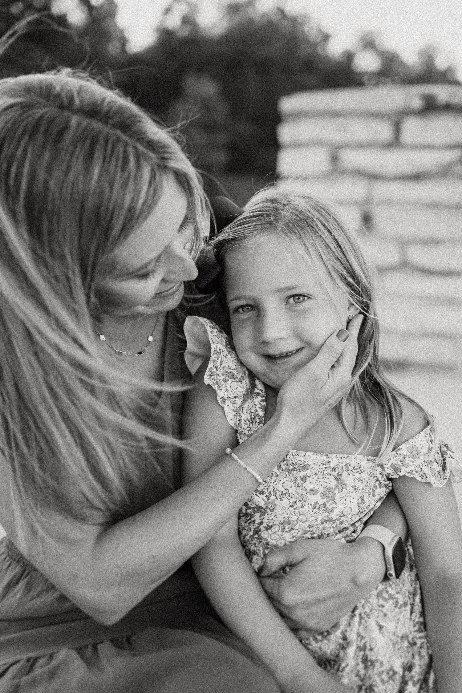 Black and white portrait capturing a tender moment of connection and joy.