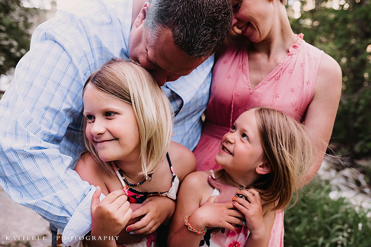 Family sharing joyful moment together outdoors in natural setting.