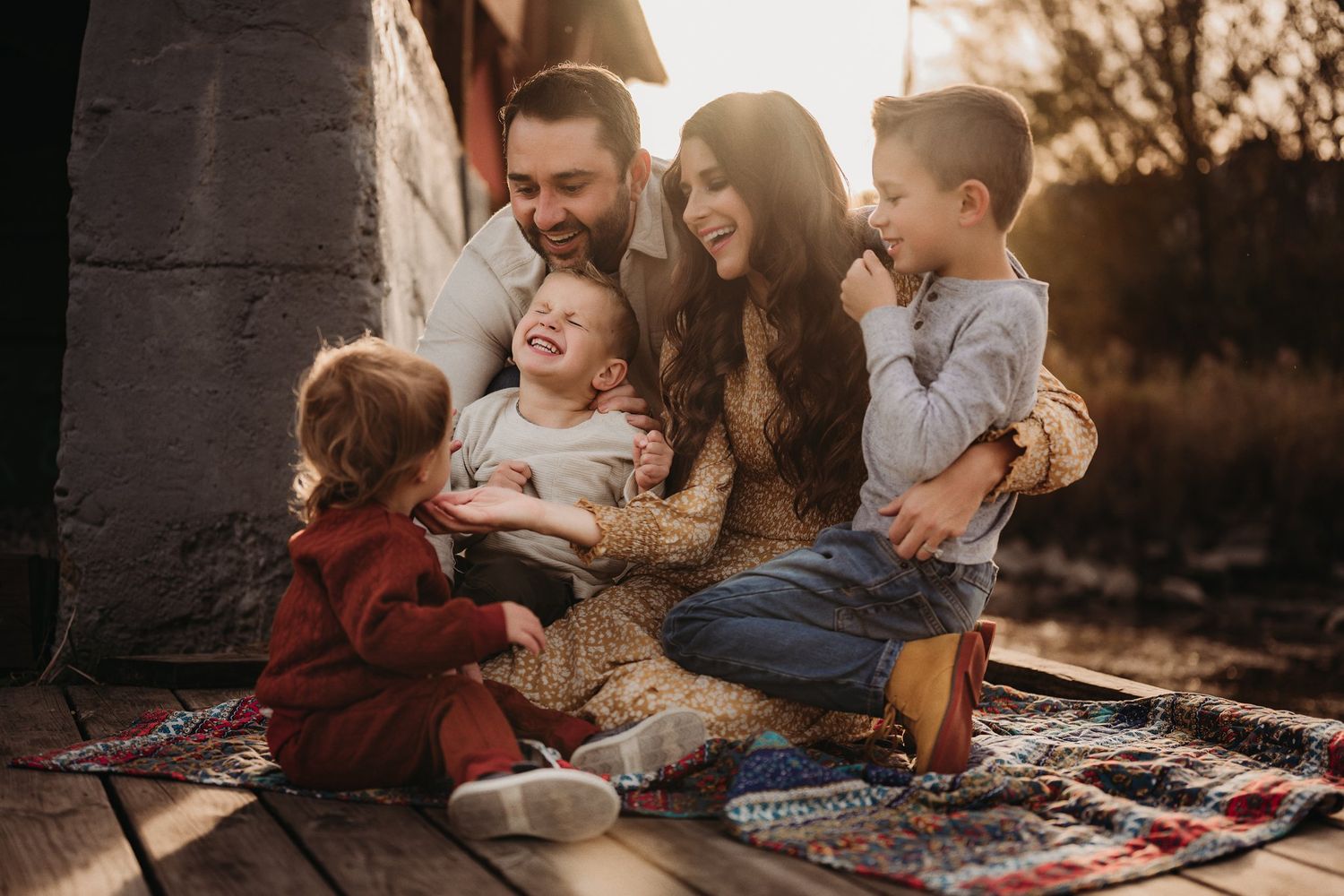 Natural family interaction during golden hour photography session outdoors.