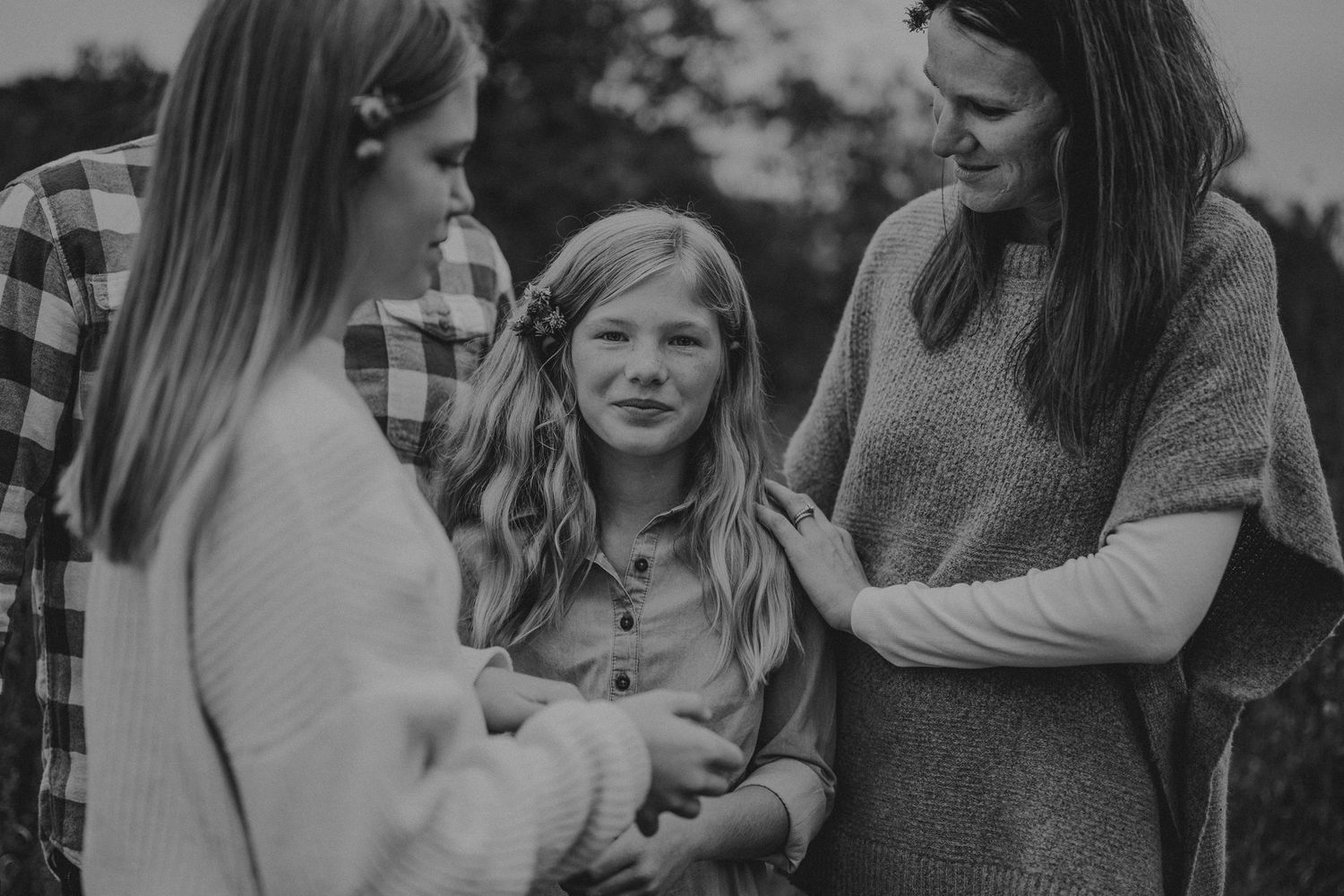 Black and white intimate family moment captured during outdoor photoshoot.
