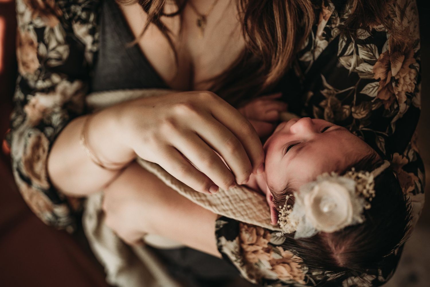Close-up of a baby wrapped in a knit blanket with delicate details.
