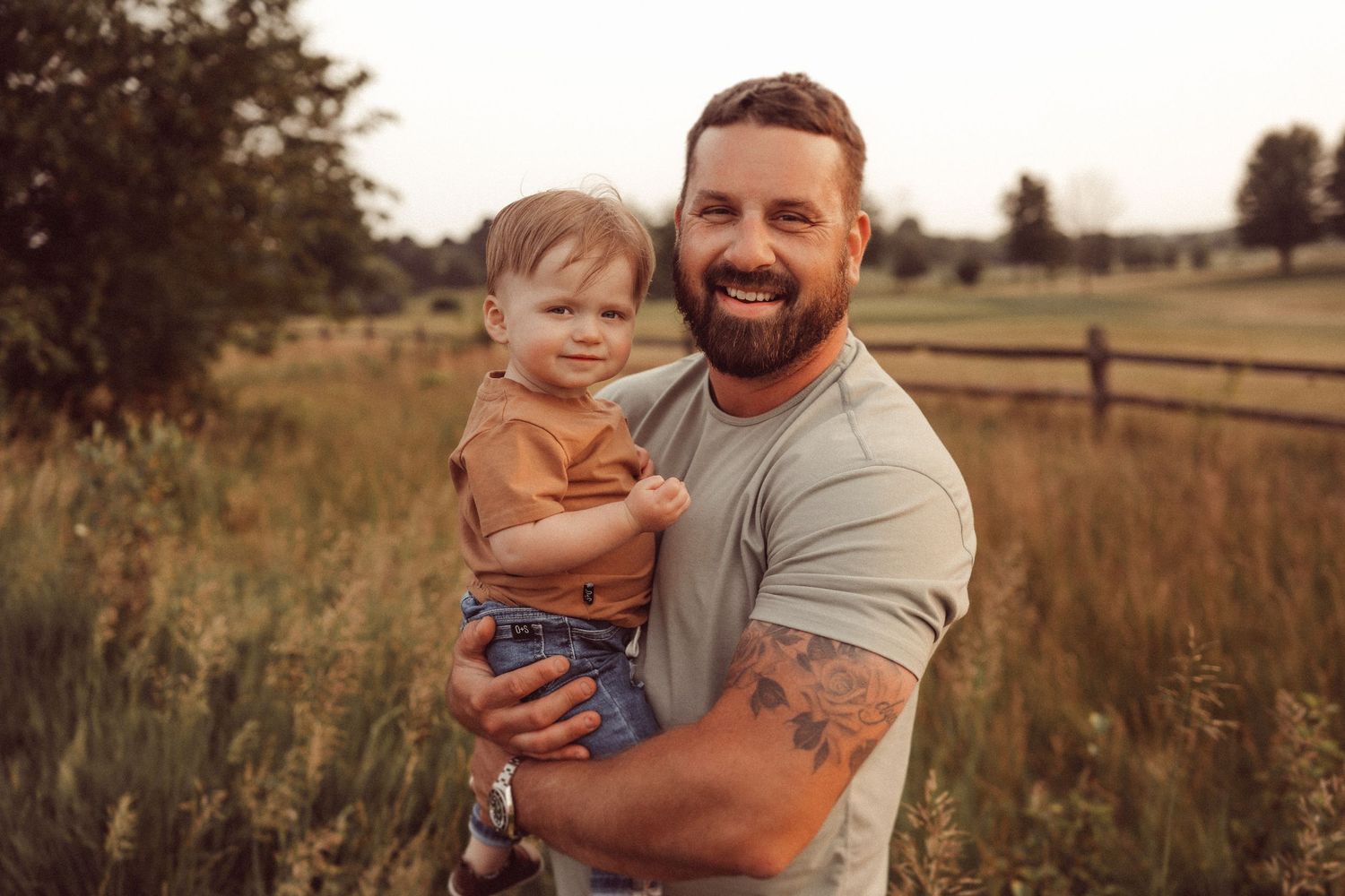 Candid portrait showing warm family connection during golden hour in a rustic outdoor setting.