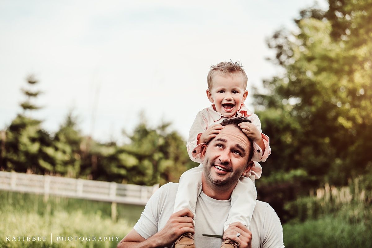Joyful outdoor moment captured in sunny field with natural backlight.