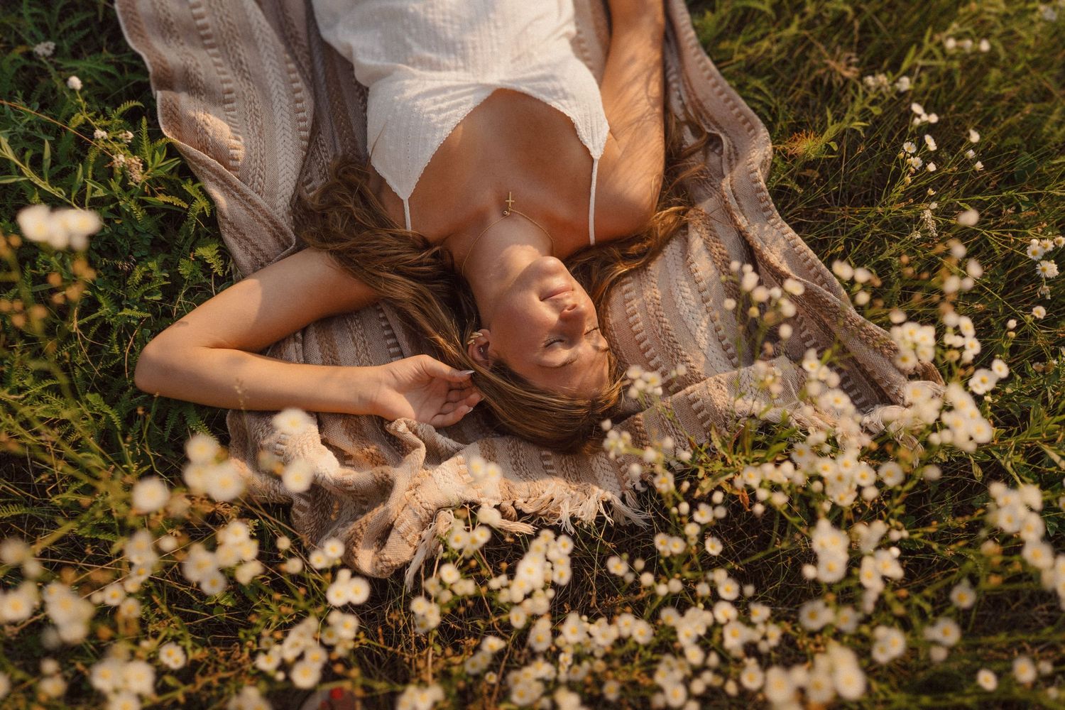 Artistic poses among white wildflowers in golden sunlight.