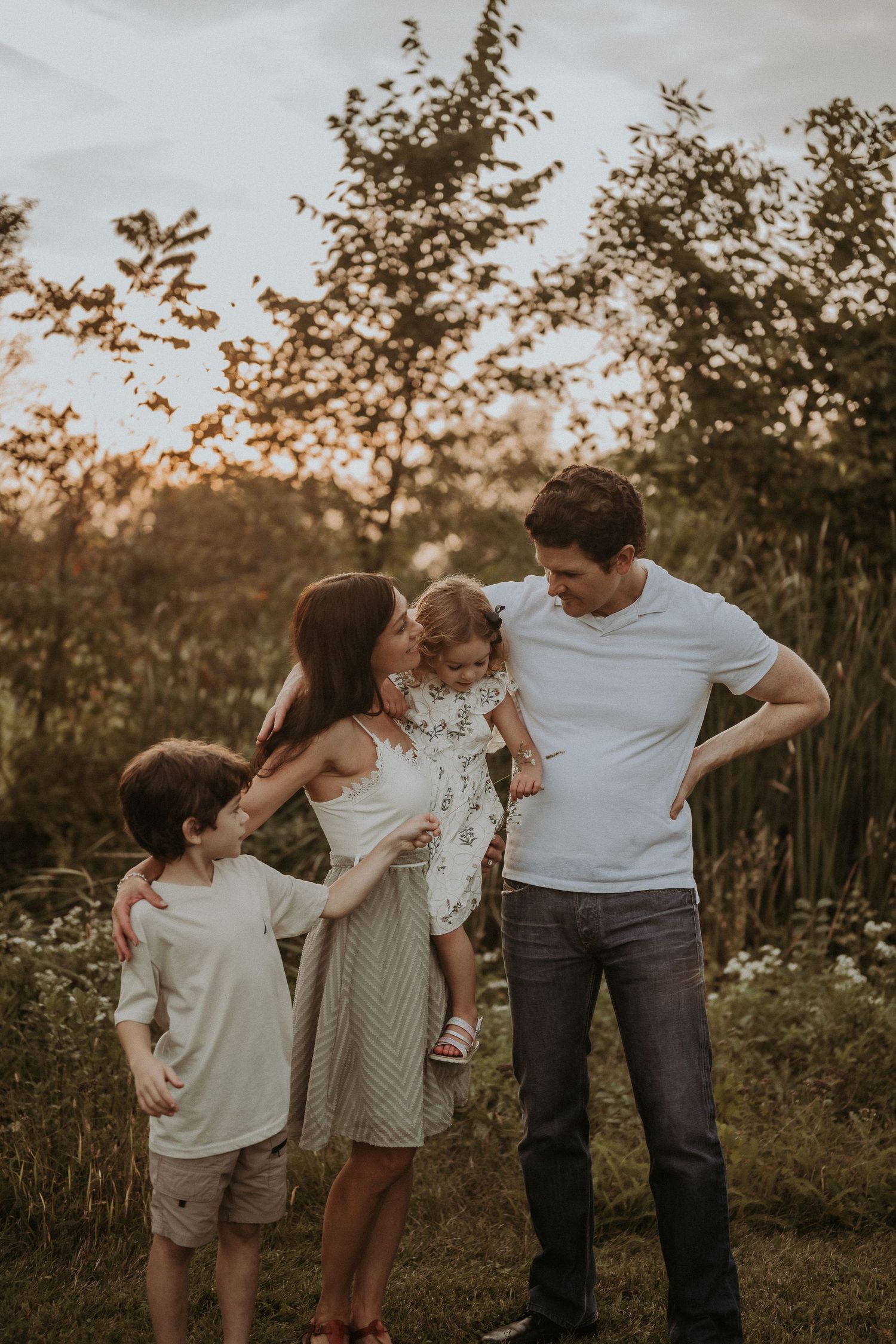 A family enjoying quality time together outdoors during golden hour.