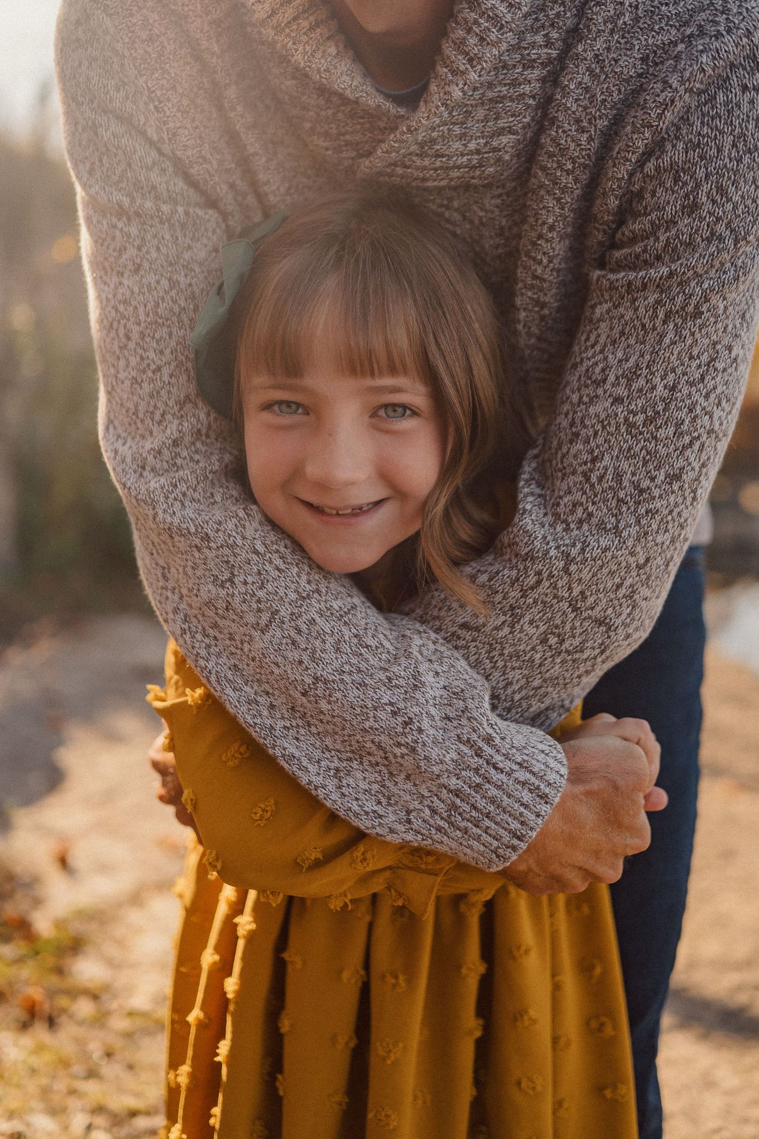 A series of photos showing someone in a cozy gray sweater and mustard yellow skirt in warm autumn sunlight.