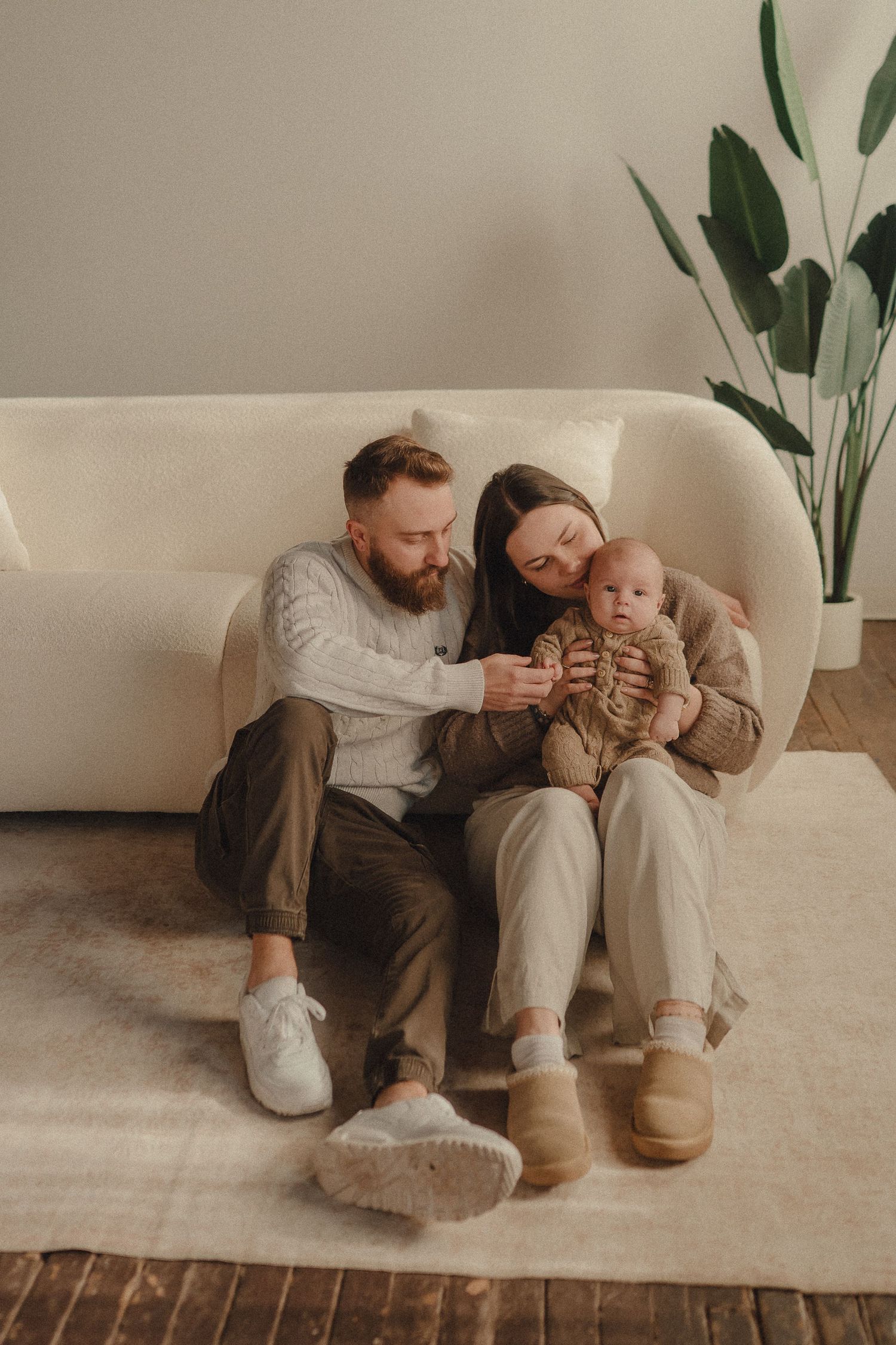 Cozy lifestyle photoshoot on a white couch with natural lighting and minimal decor.
