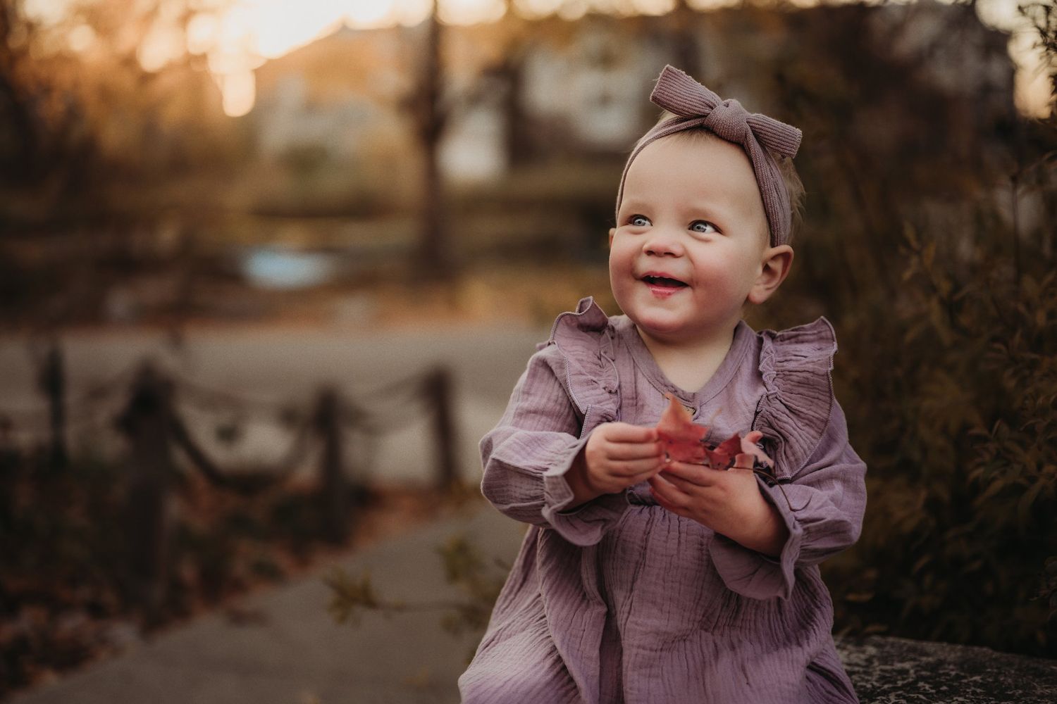 Sweet moment captured in pink dress during golden hour.