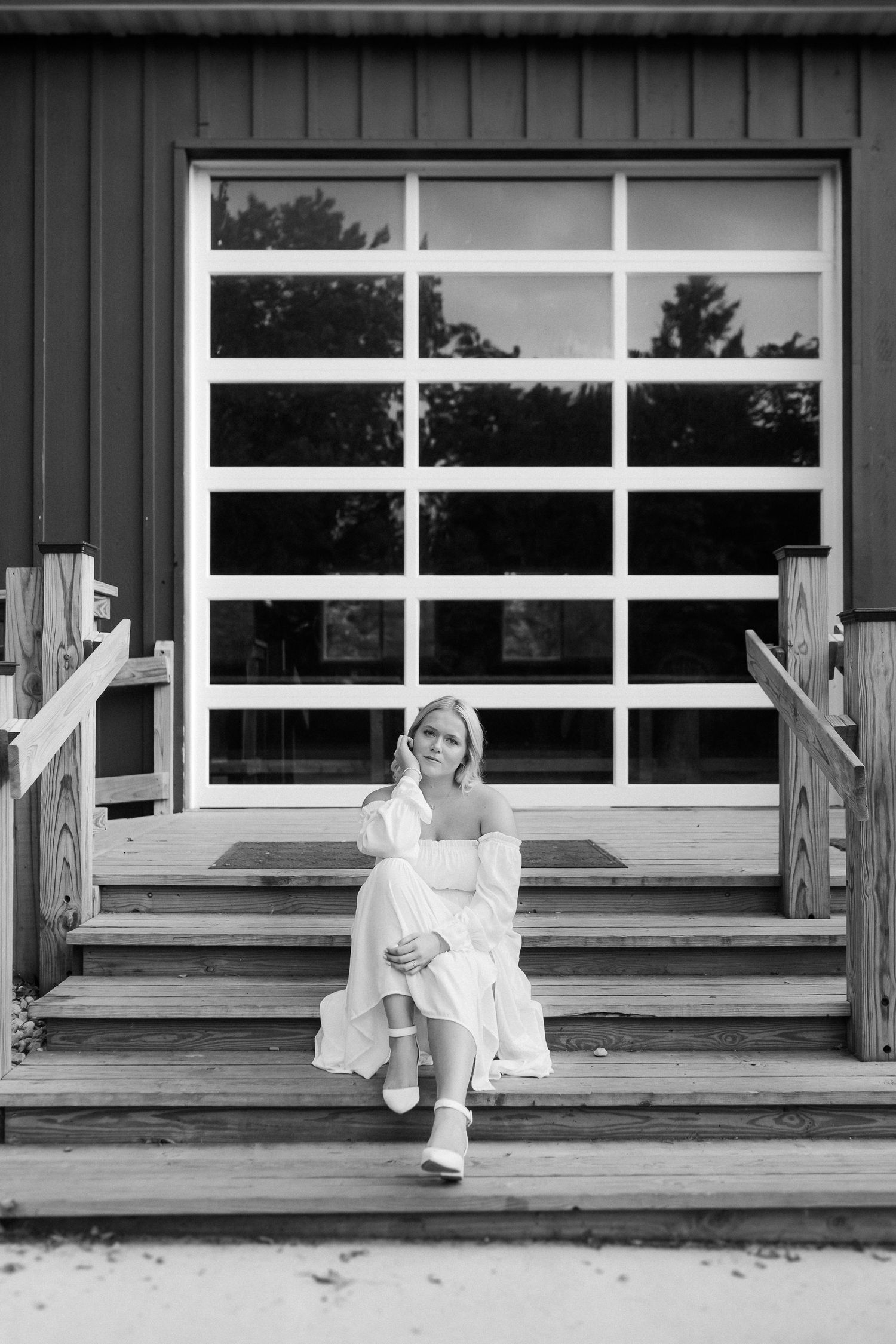 Artistic black and white portrait series on a wooden porch with rustic windows.