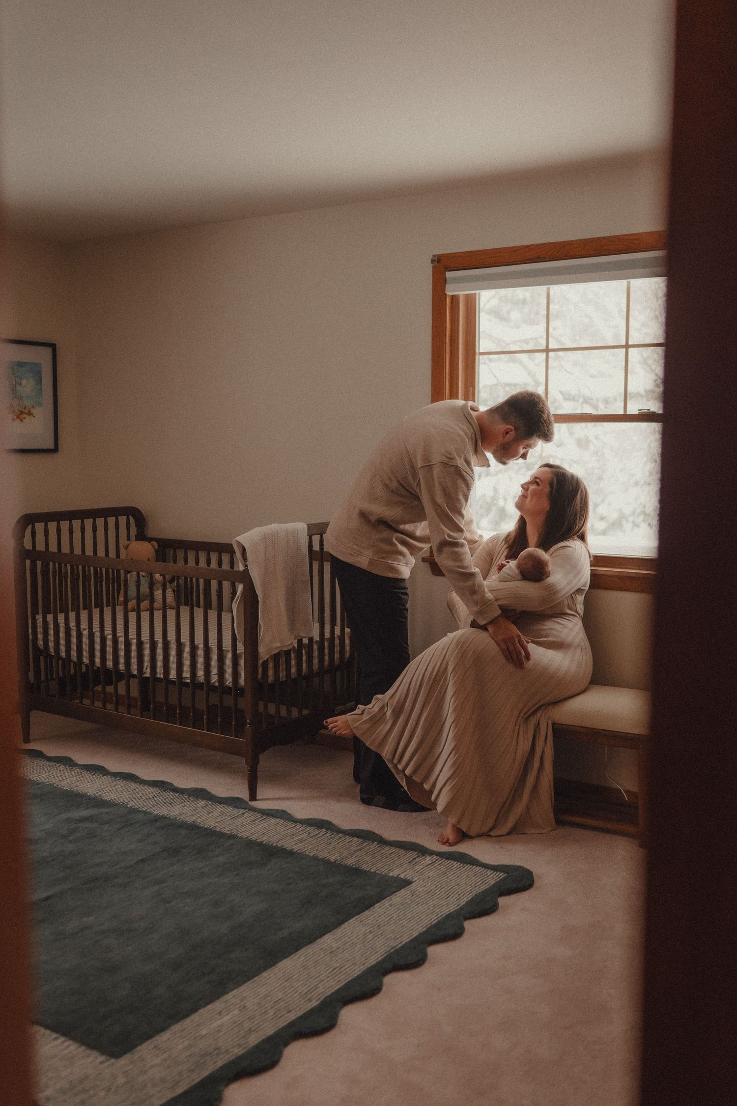 Interior room sequence with dark furniture and window light creating moody atmosphere.