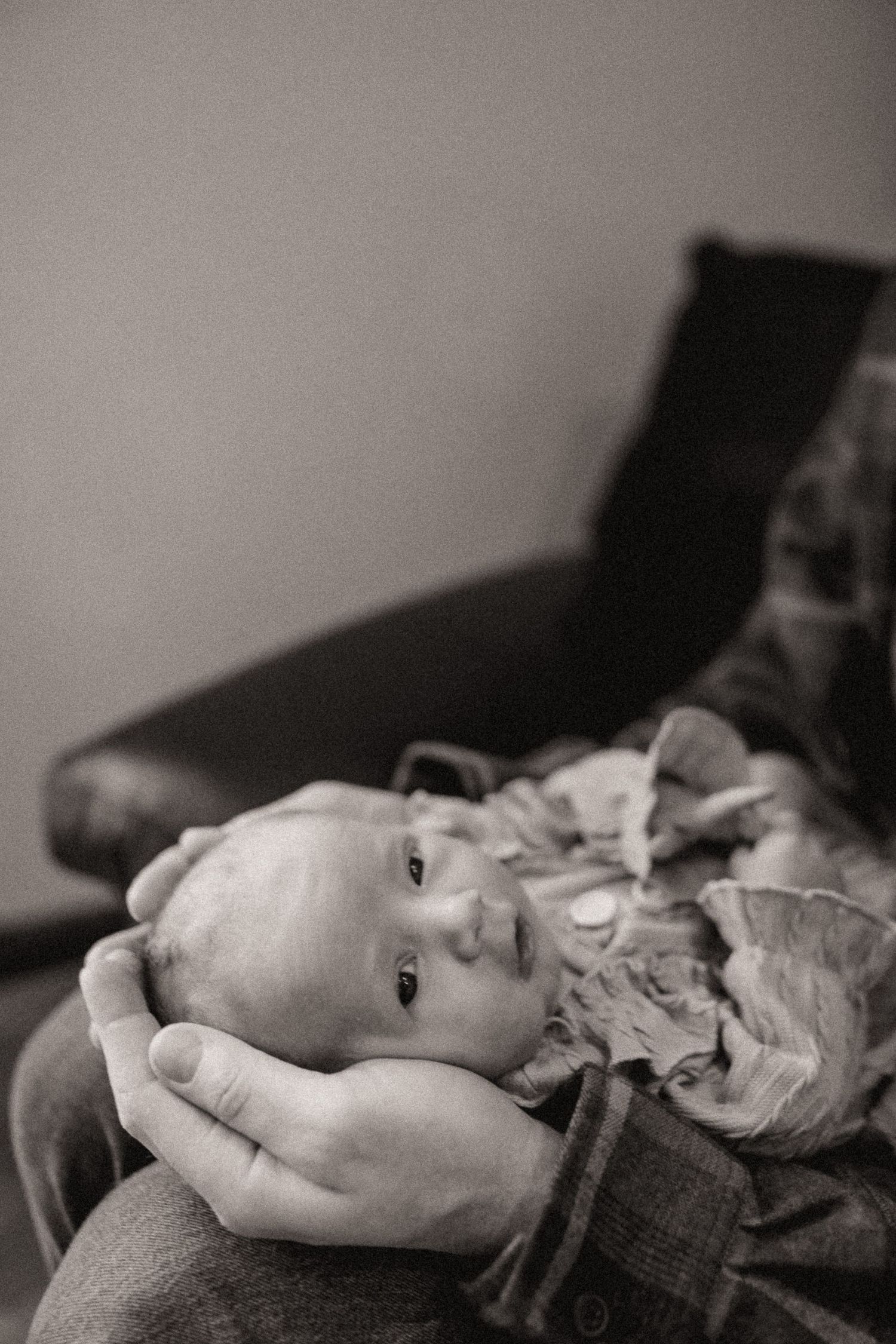 Black and white artistic portrait showing a person lying down in a contemplative pose.