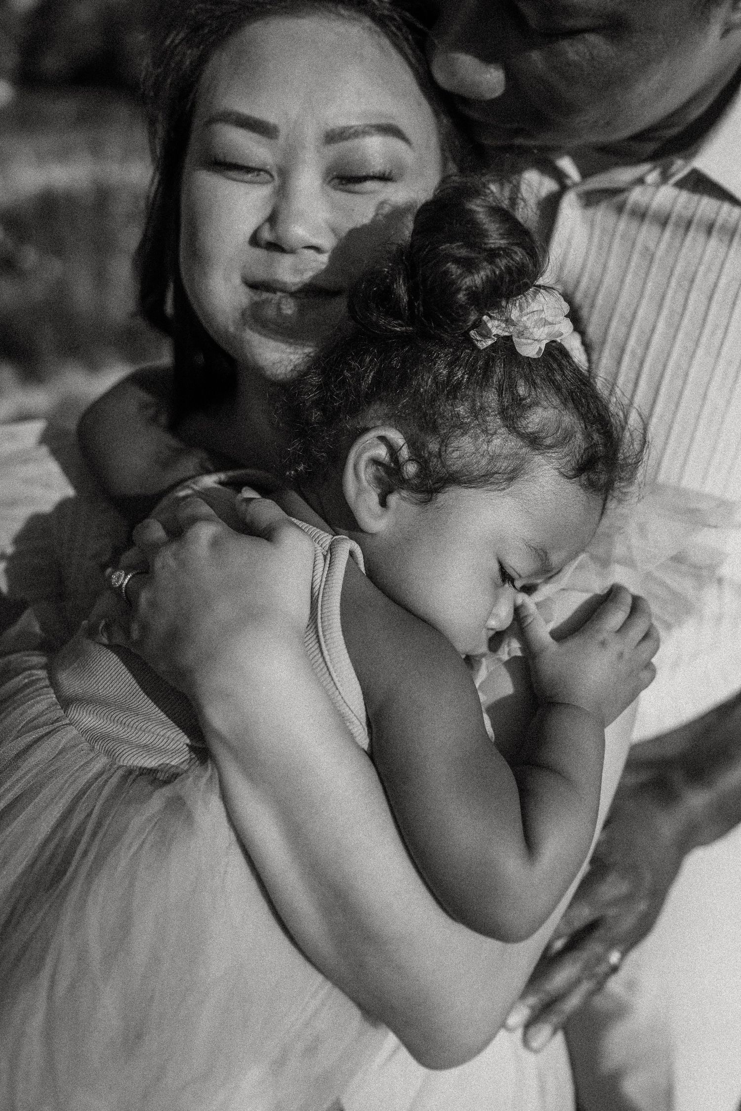 Tender black and white portrait capturing a peaceful family moment outdoors.