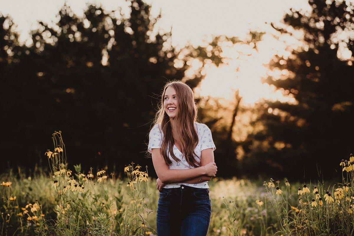 A joyful moment captured at golden hour in a wildflower field with warm sunset lighting.