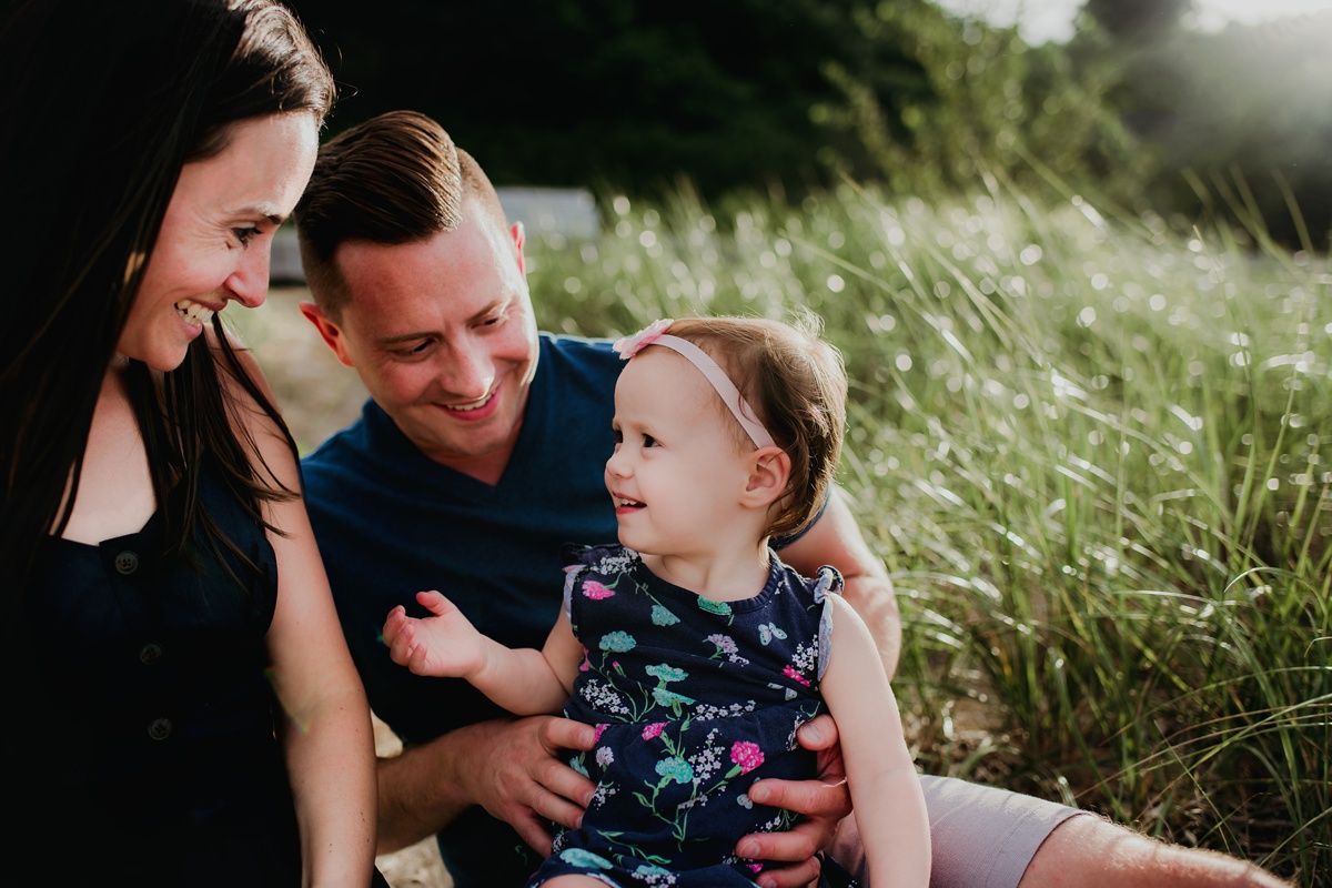 An intimate family moment outdoors with joyful expressions and natural scenery.