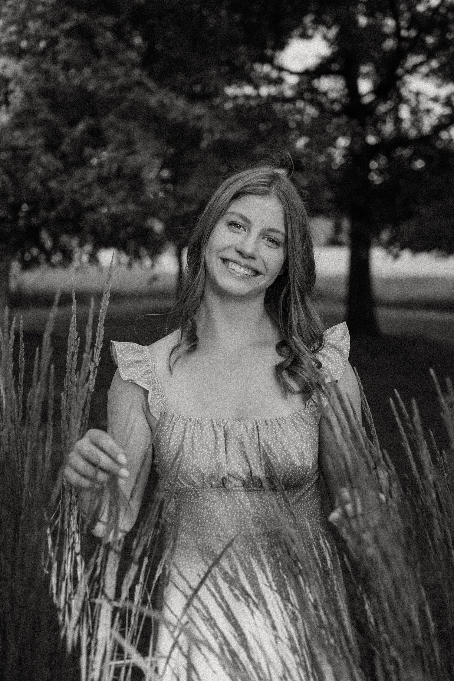 Natural portrait among tall ornamental grasses in a tranquil park setting.