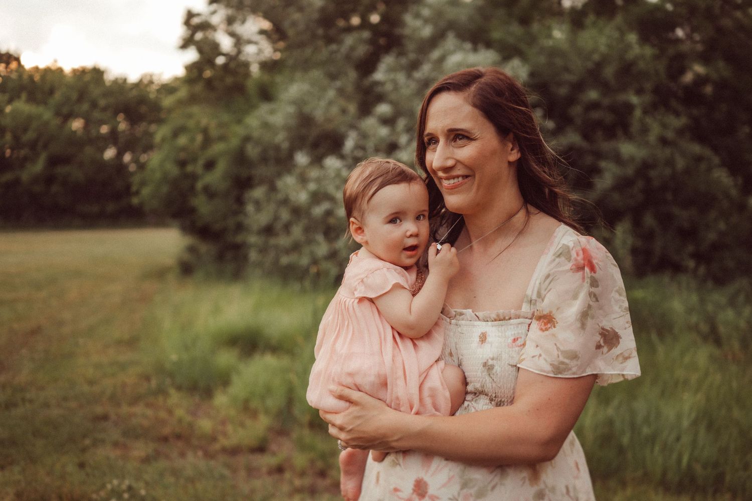 A joyful outdoor portrait showing affection in a floral dress.