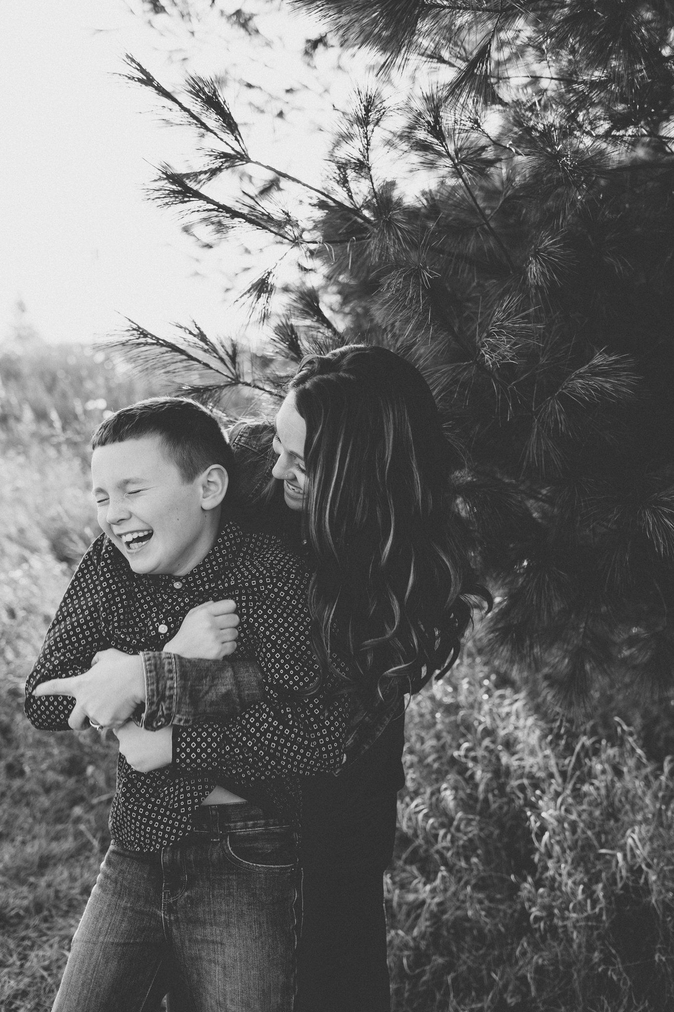 A black and white photo capturing a moment of genuine laughter and joy.