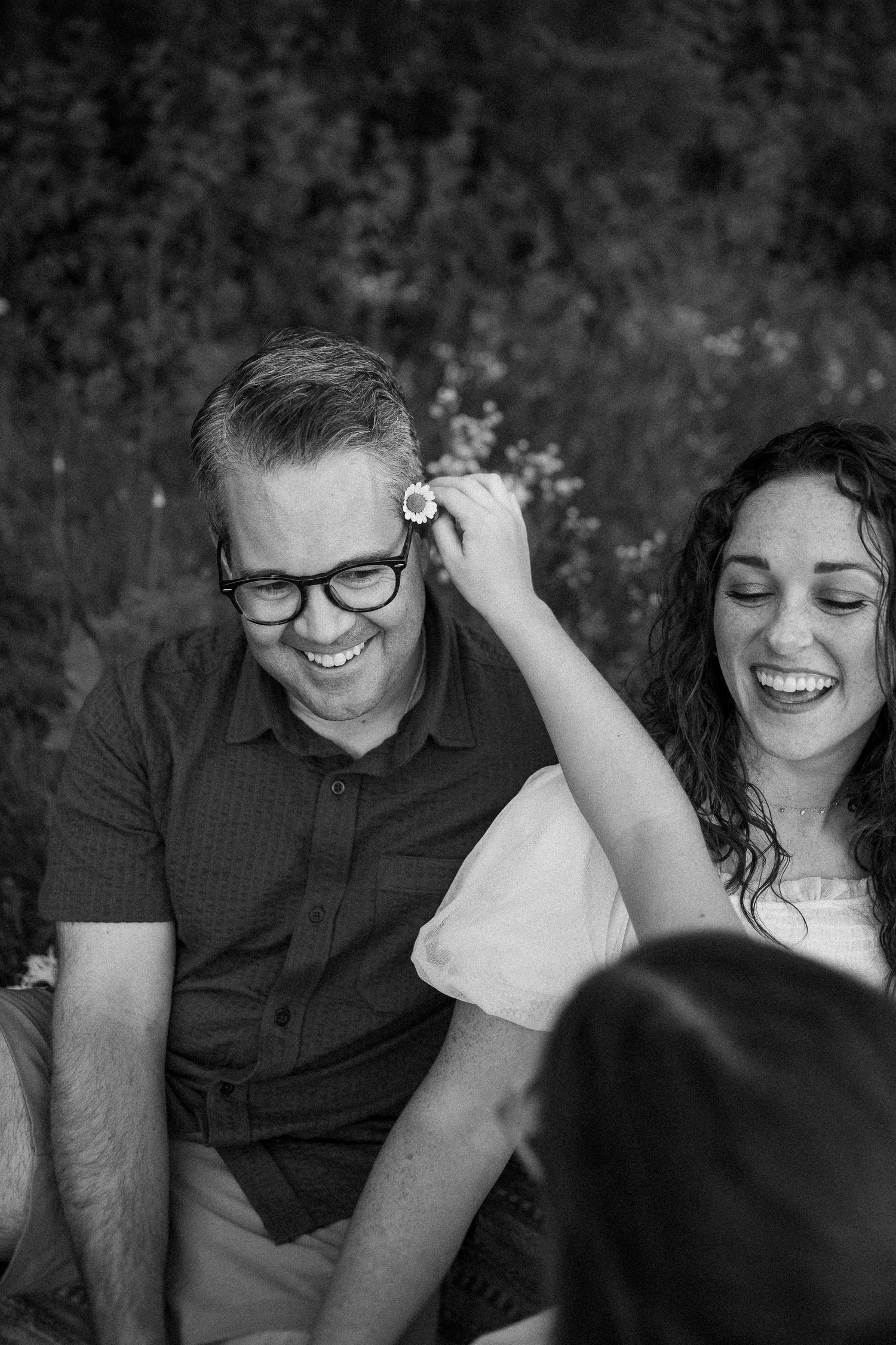 A black and white series of intimate romantic moments showing genuine laughter and connection.