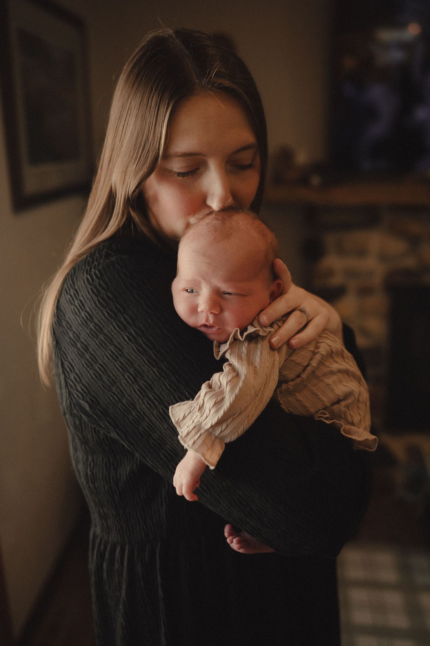 Moody indoor photography sequence showing tender moments and connection in dim lighting.