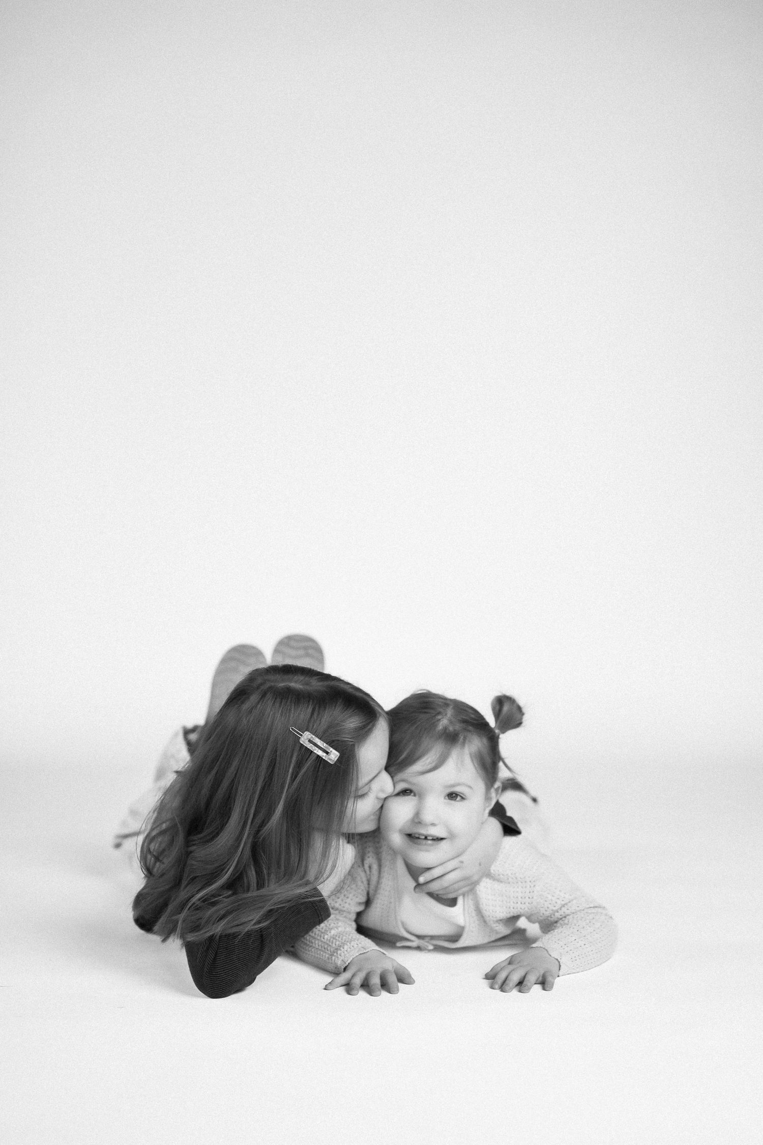 Series of candid black and white photos showing playful interactions on a white background.