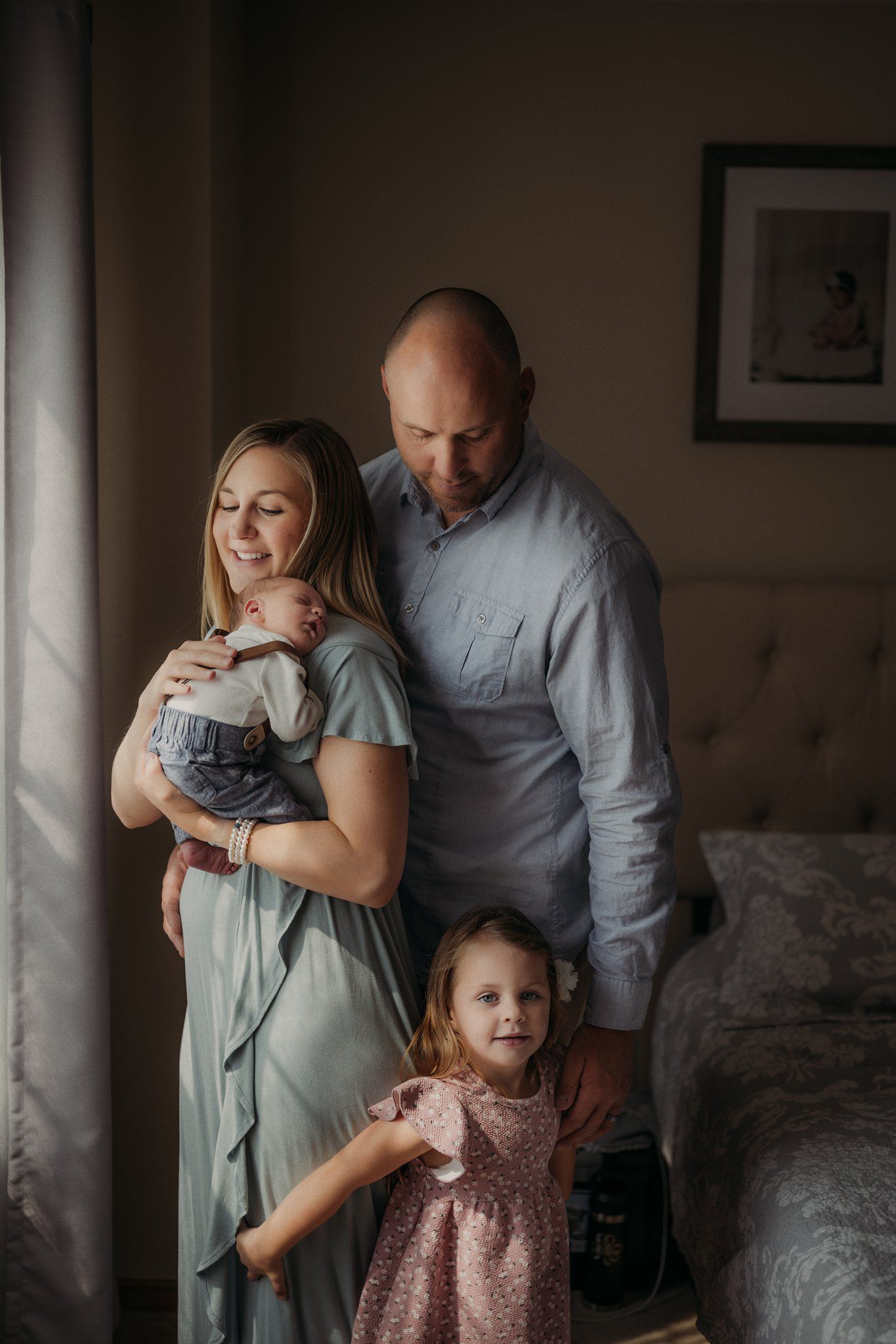 Heartwarming family moment captured by window with soft natural light.