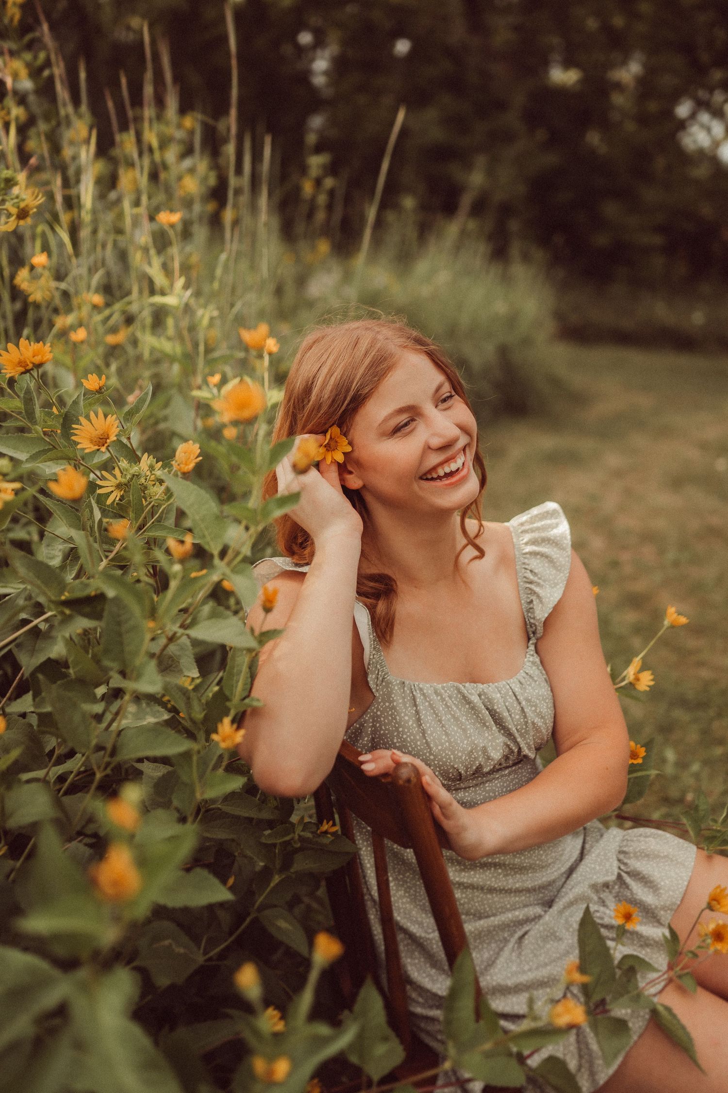 Warm toned portrait among orange wildflowers with a vintage-inspired grey dress.