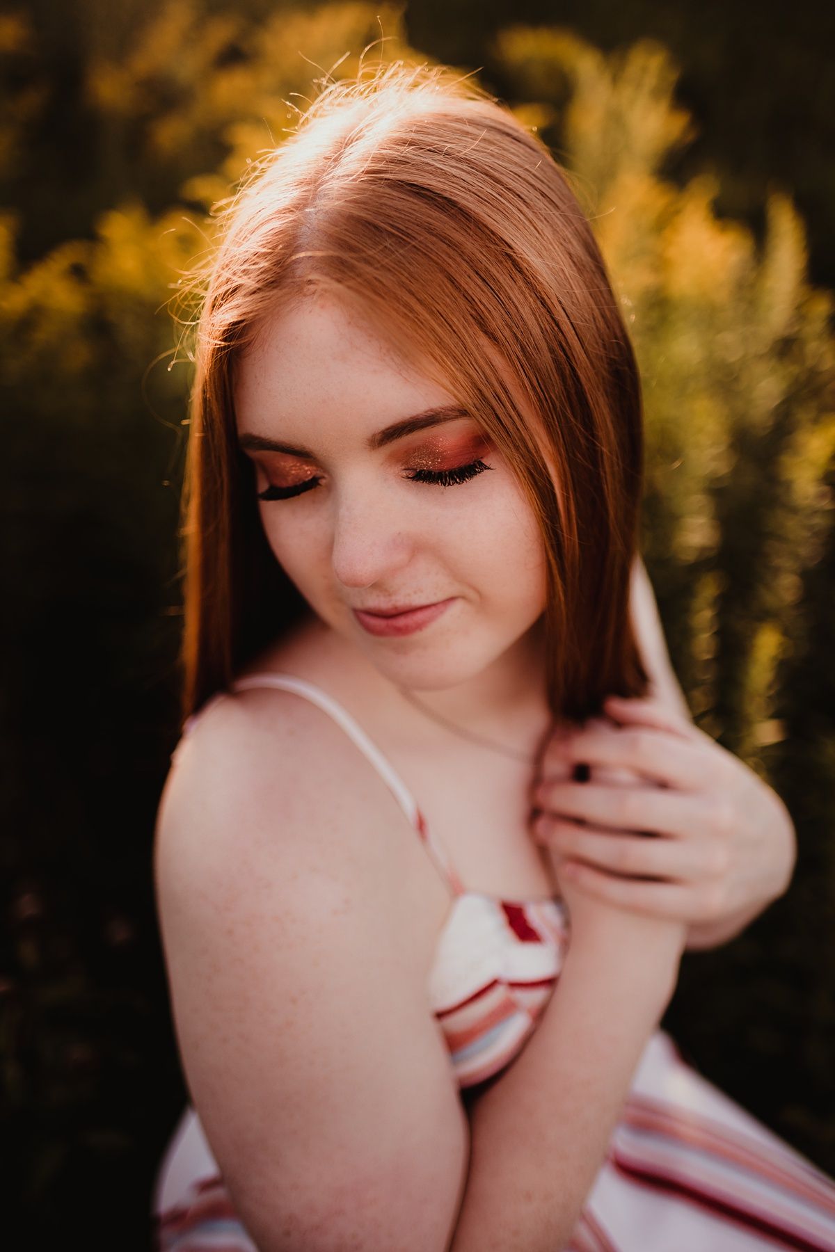 A close-up portrait with soft lighting and delicate styling against a golden background.