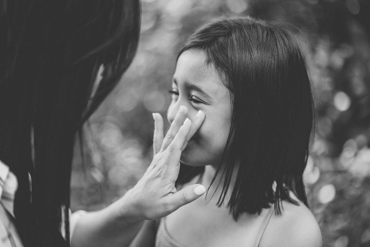 Black and white portrait capturing joyful laughter between two people.