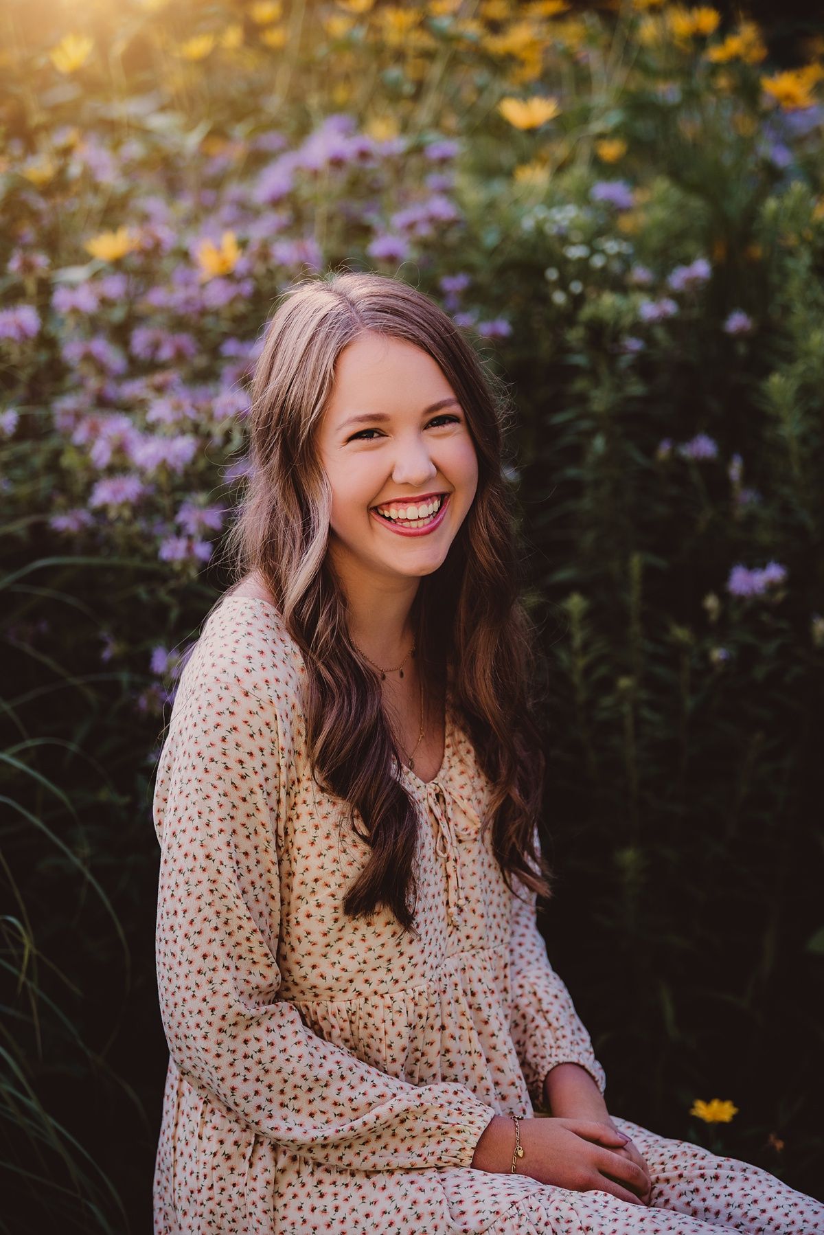 A floral polka dot dress in golden sunlight with purple wildflowers in the background.