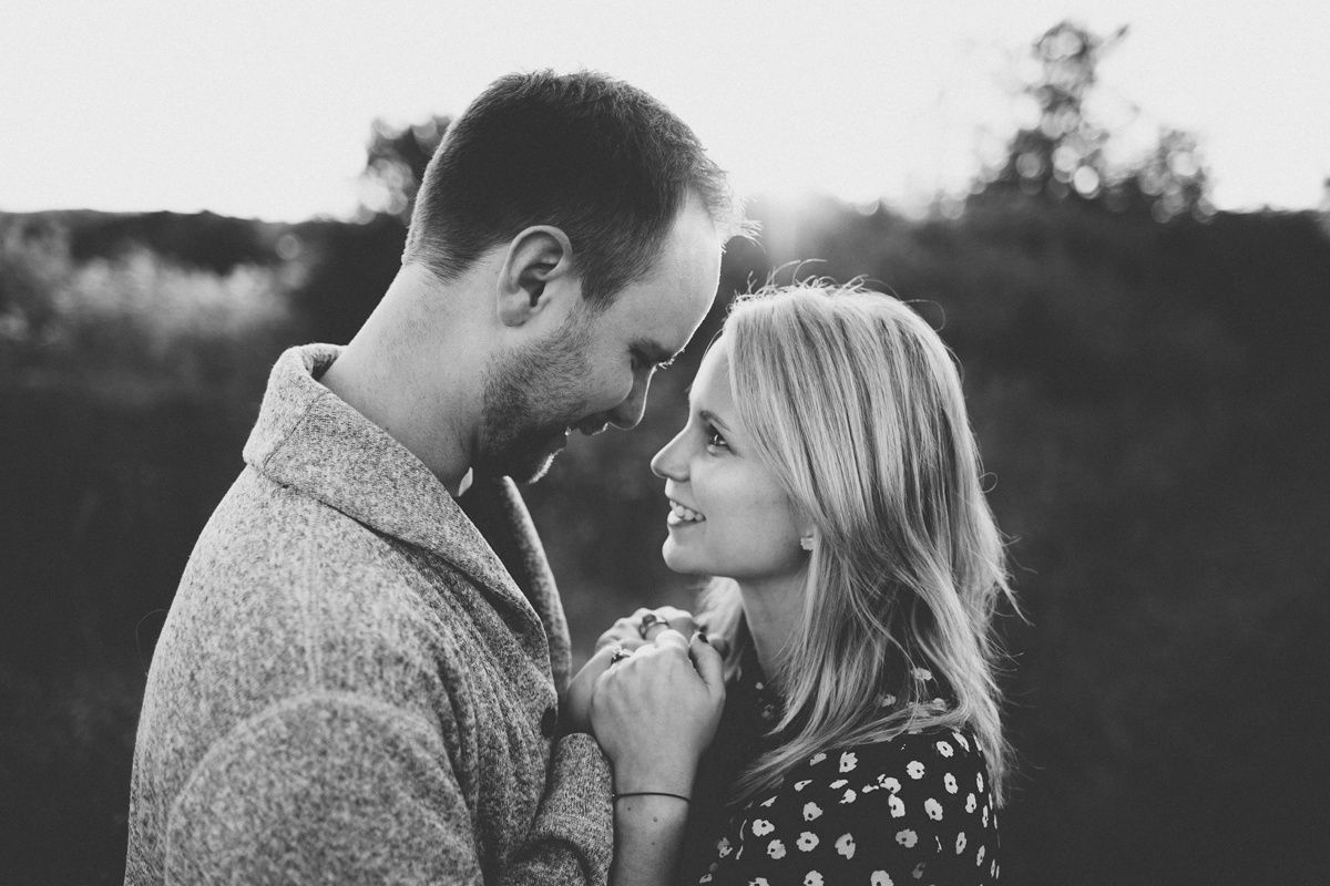 Intimate black and white portrait of couple sharing a tender moment together.