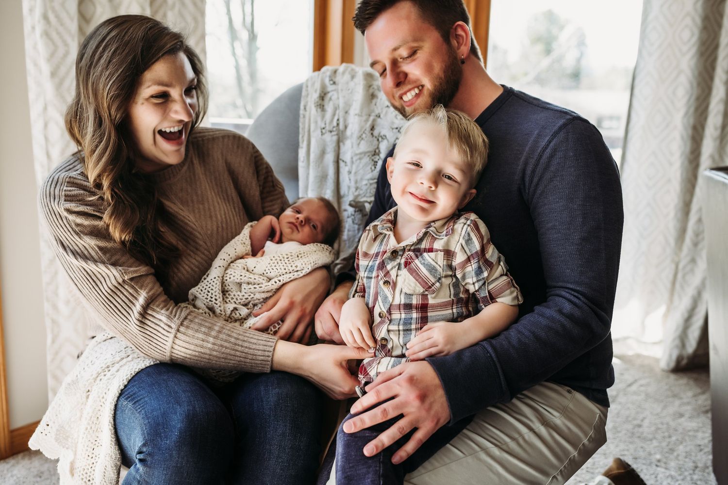 Joyful family moment captured by window with everyone sharing laughter together.