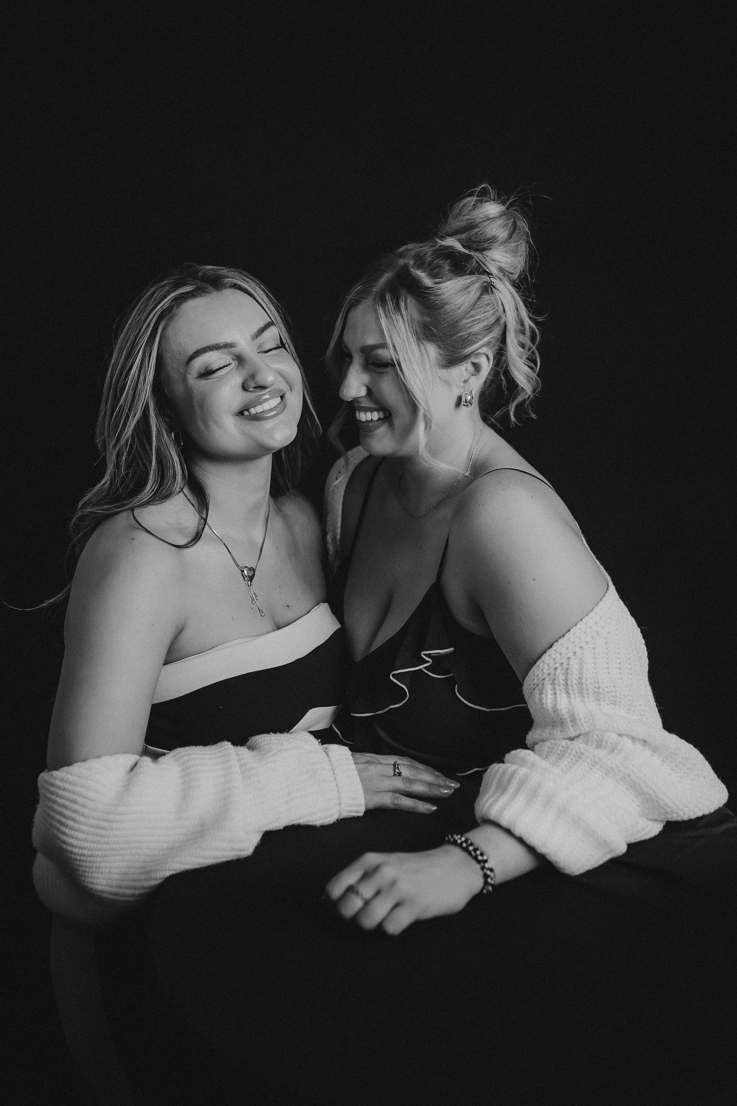 Artistic black and white portraits of two people in white tops sharing intimate moments.