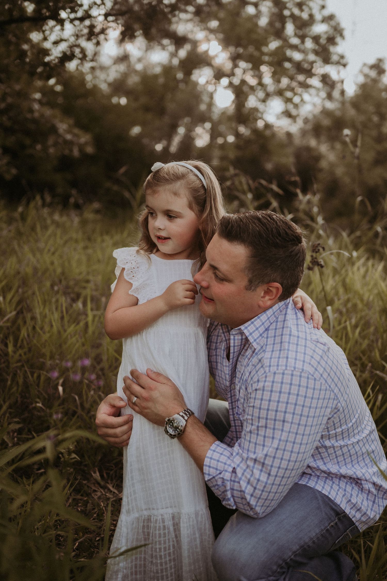 Tender moment shared between two people in a field during golden hour.