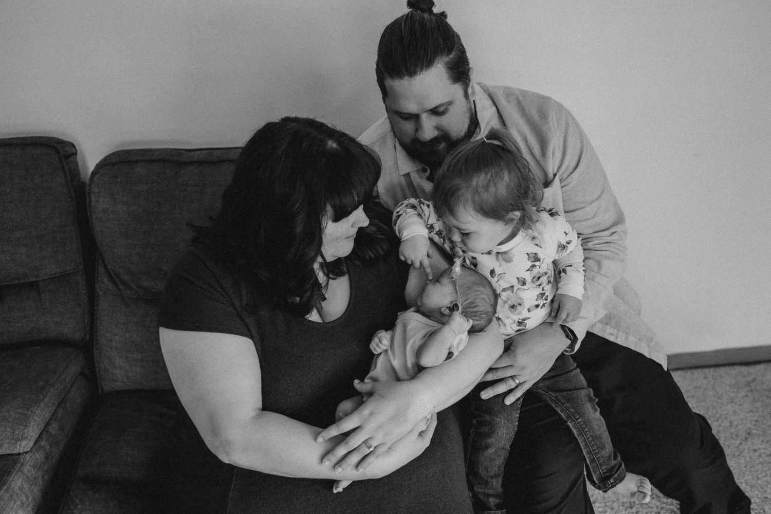Black and white portrait of a family sharing an intimate moment together.