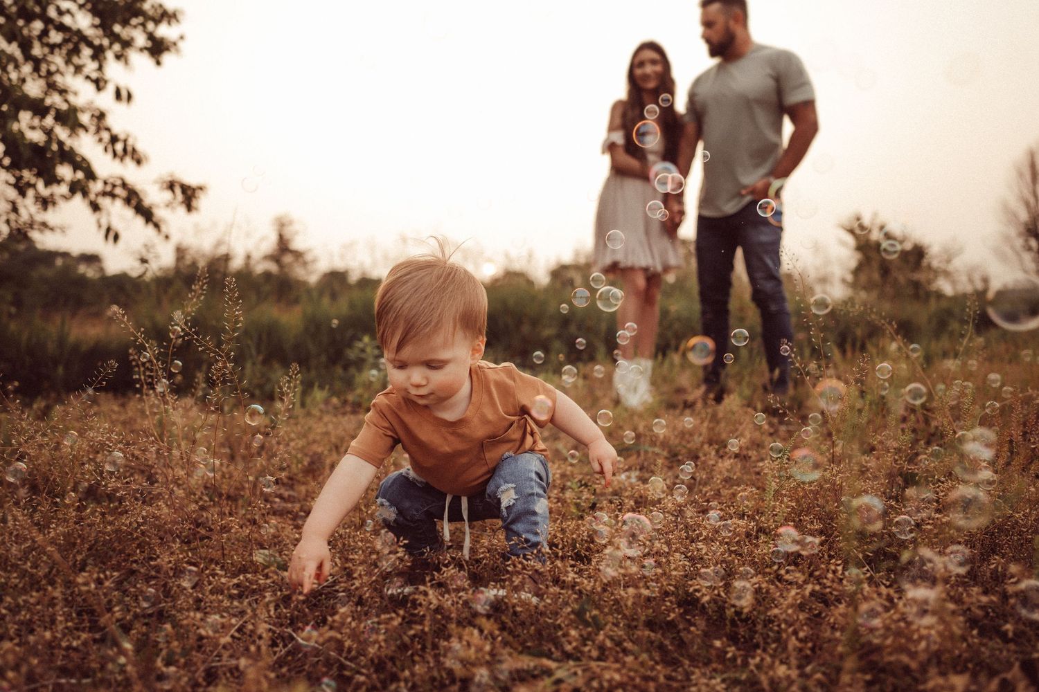 Candid family moment in a wildflower field during golden hour.