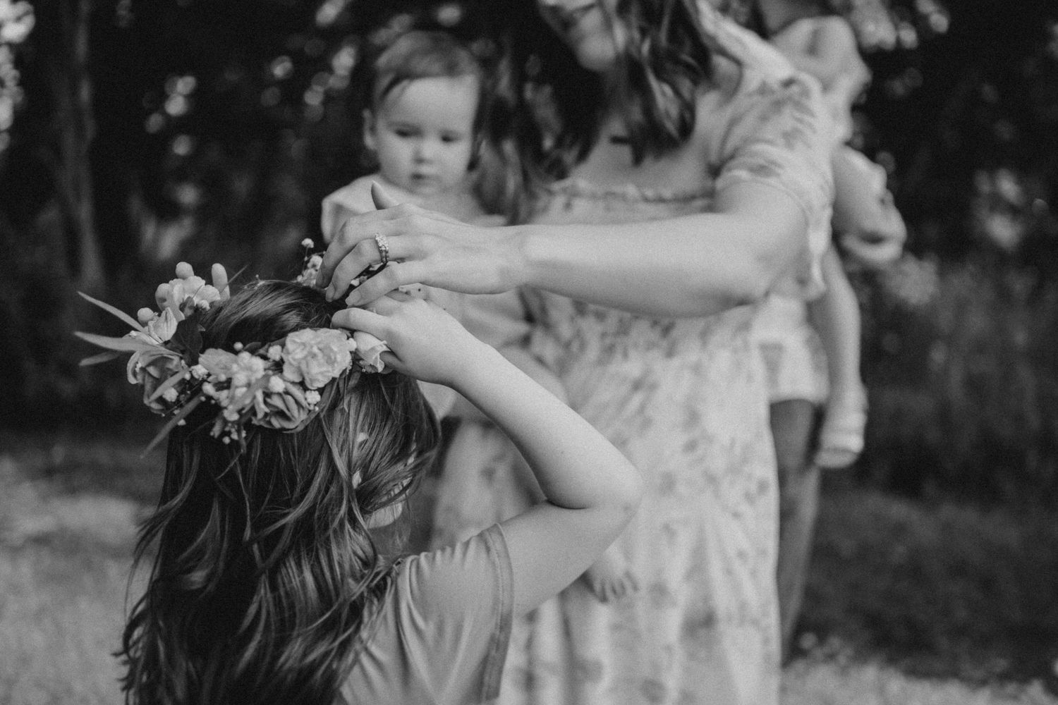 A black and white photo showing a group sharing flowers in an outdoor setting.