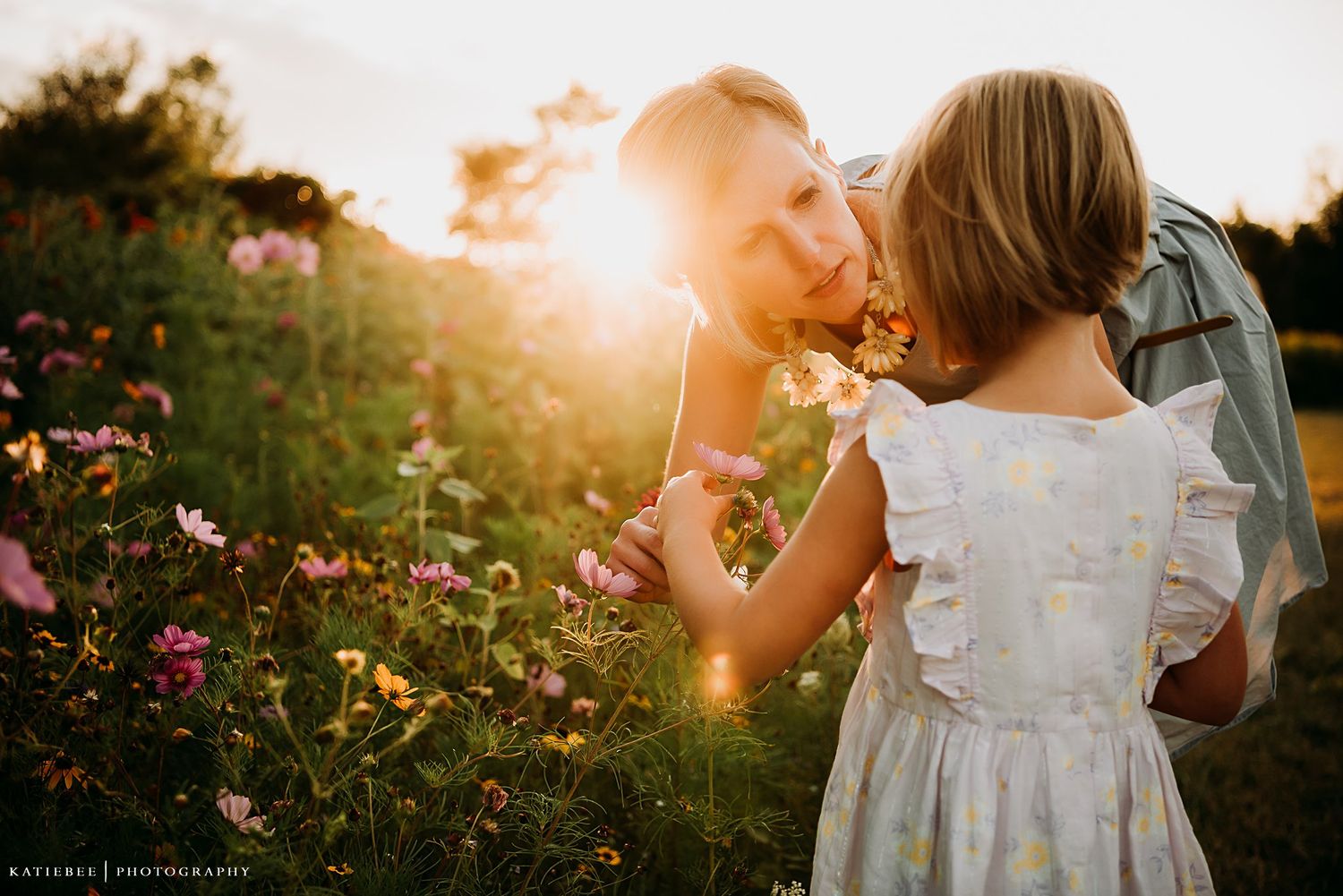 Tender moment shared in a flower garden during golden sunset hour.