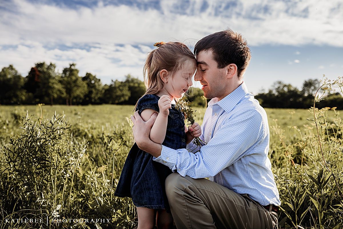 A tender moment shared between parent and child in a sunlit meadow on a beautiful summer day.