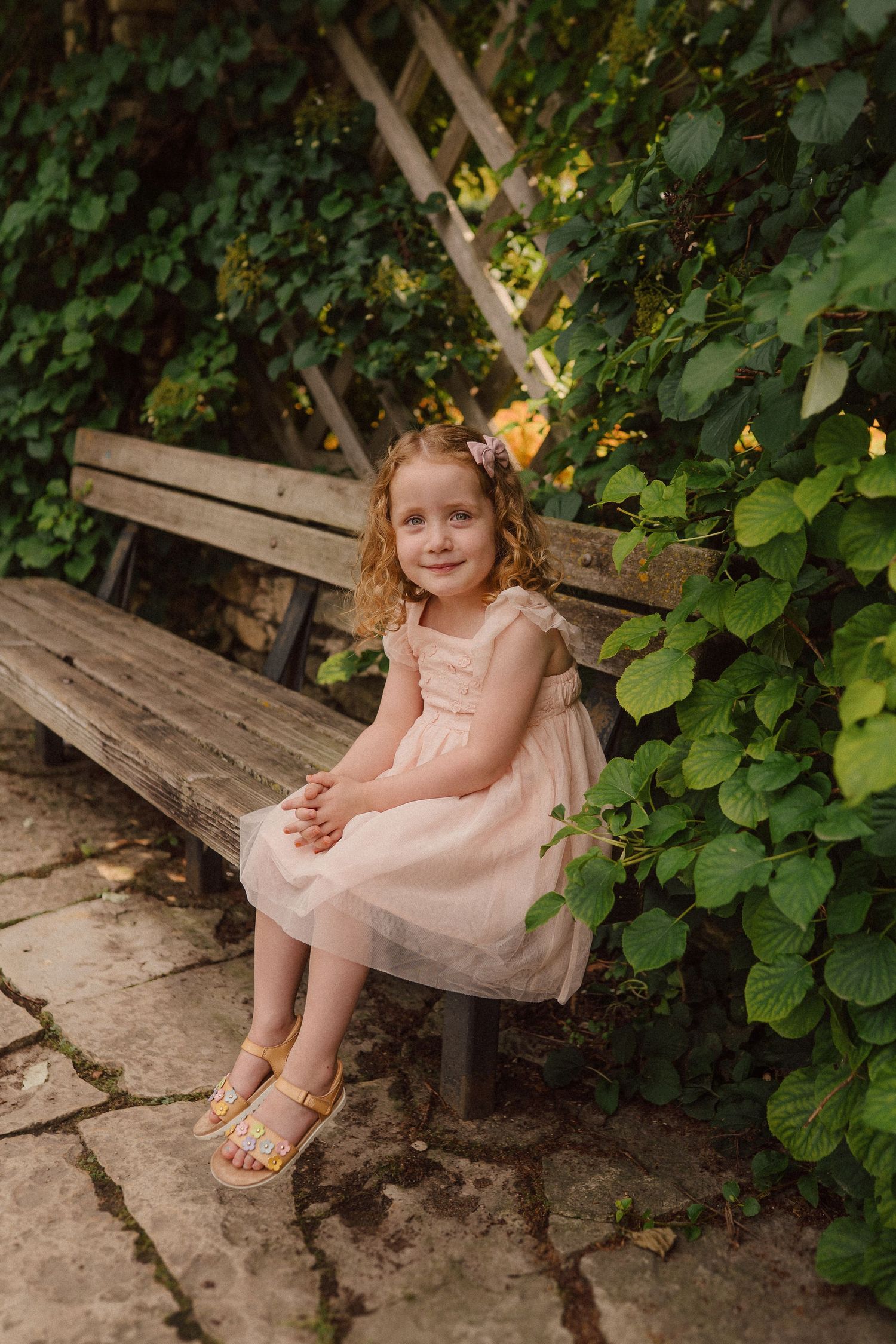 A dreamy garden scene with a wooden bench surrounded by climbing vines and yellow flowers.