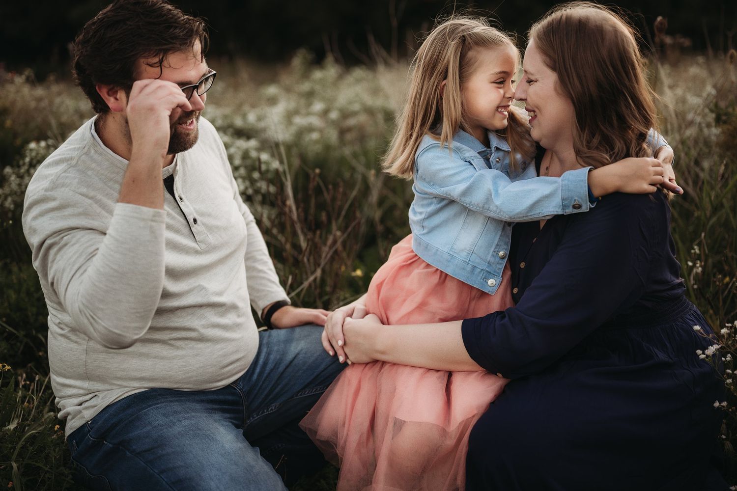 Intimate family moment shared during outdoor portrait session.
