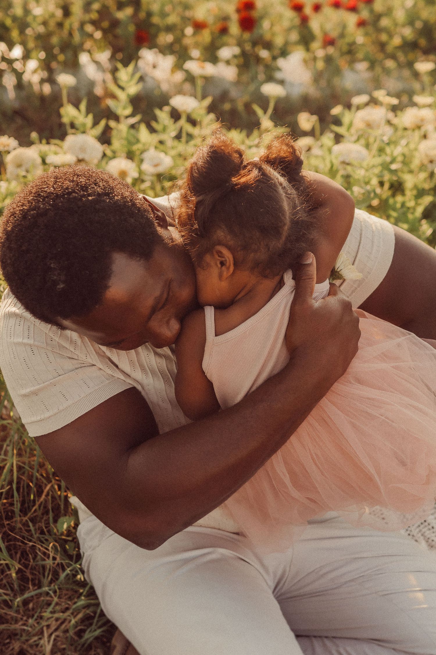 An intimate embrace shared between parent and child in a blooming garden.