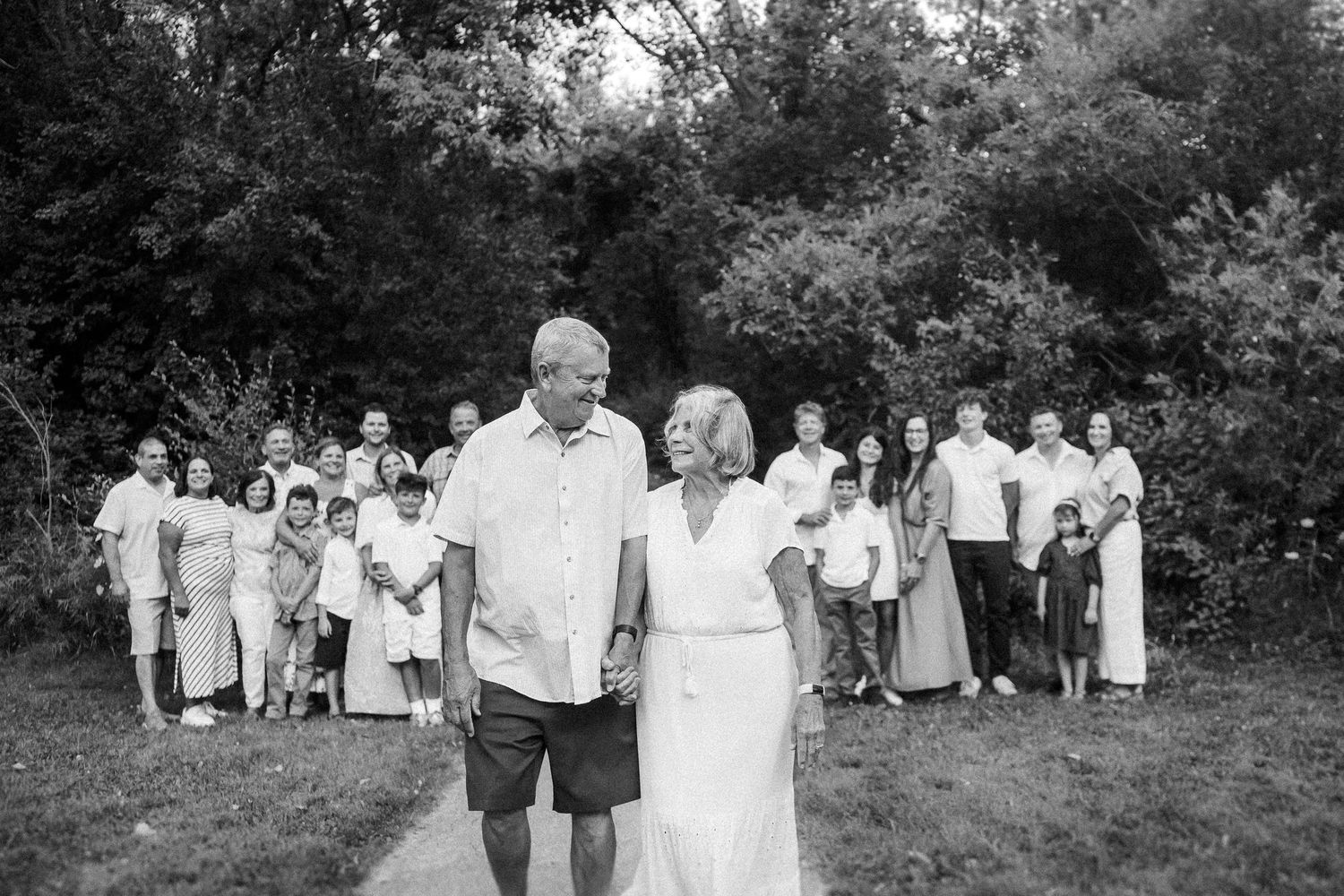 Black and white group portrait of extended family gathered outdoors.