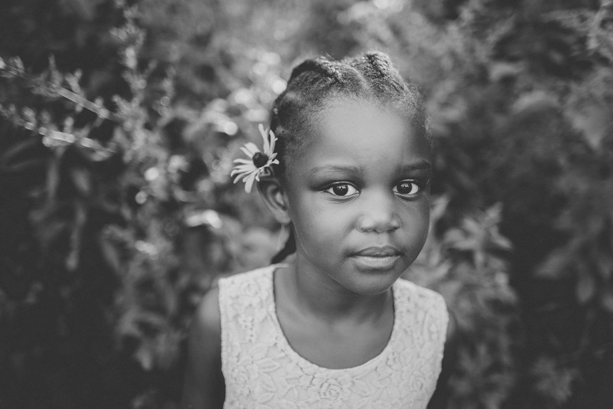 A striking black and white portrait capturing an expressive moment outdoors.