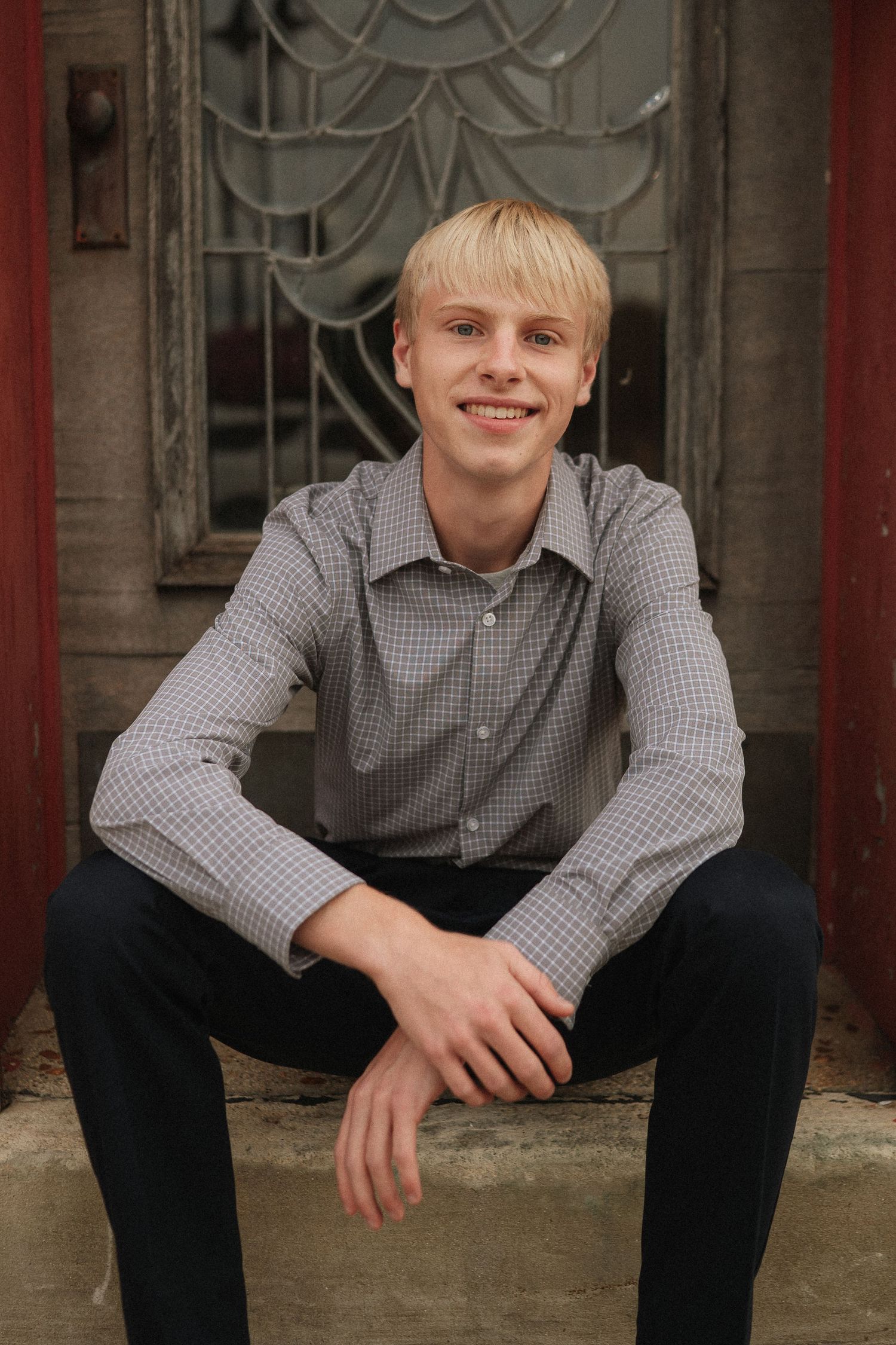 Series of casual portraits taken against a decorative red and stone architectural backdrop.