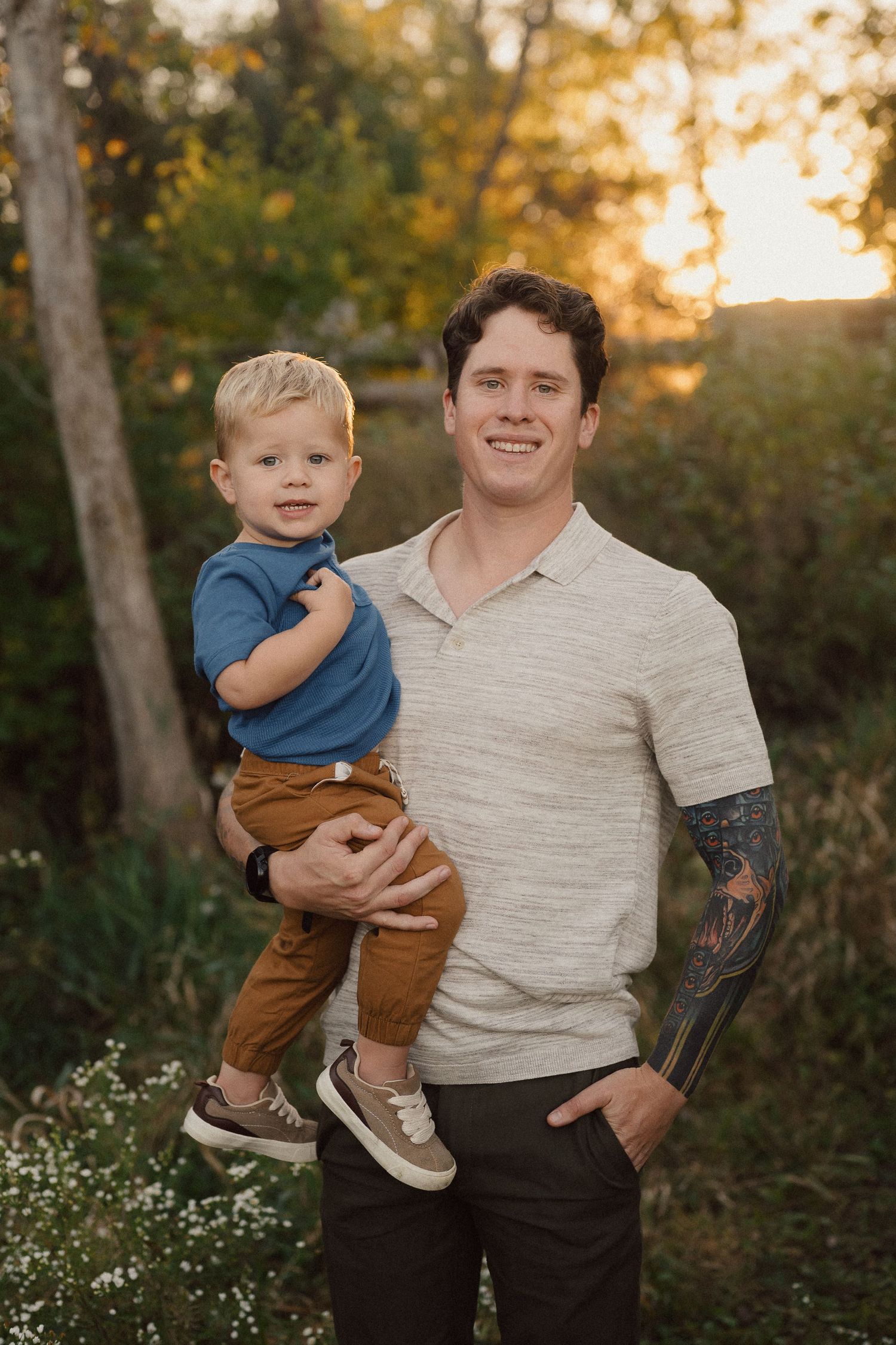 Family portrait in a natural wooded setting during golden hour.