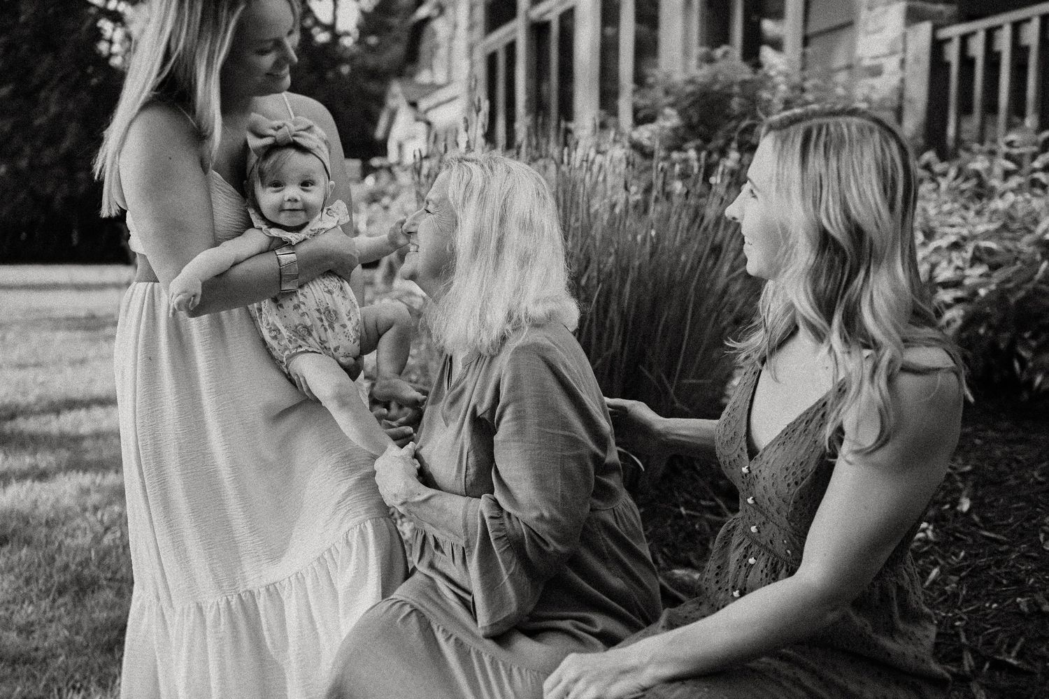 A black and white photo of a relaxed gathering by flowering lavender plants.