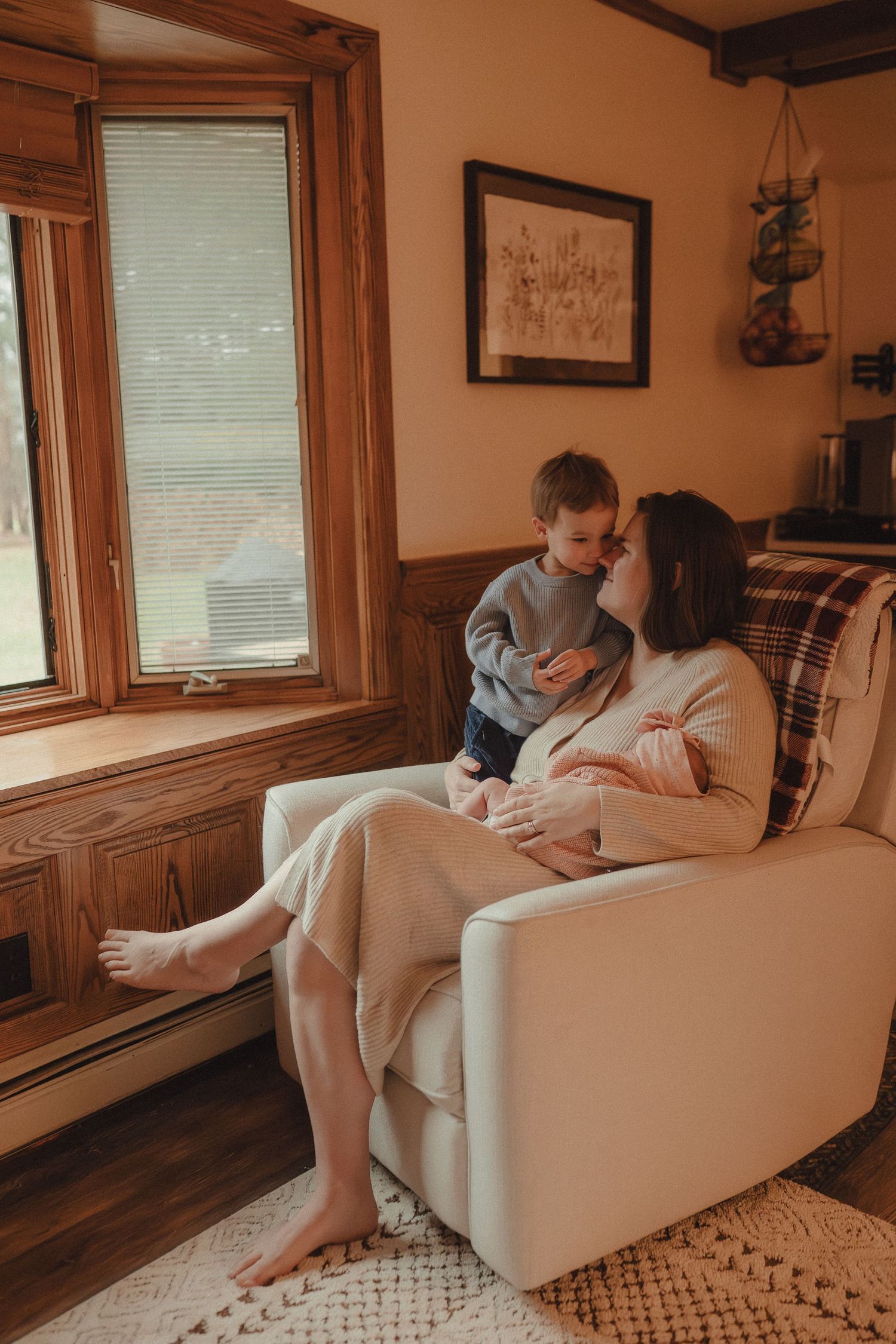 Intimate home scene showing relaxed moments on a comfortable white armchair near windows.